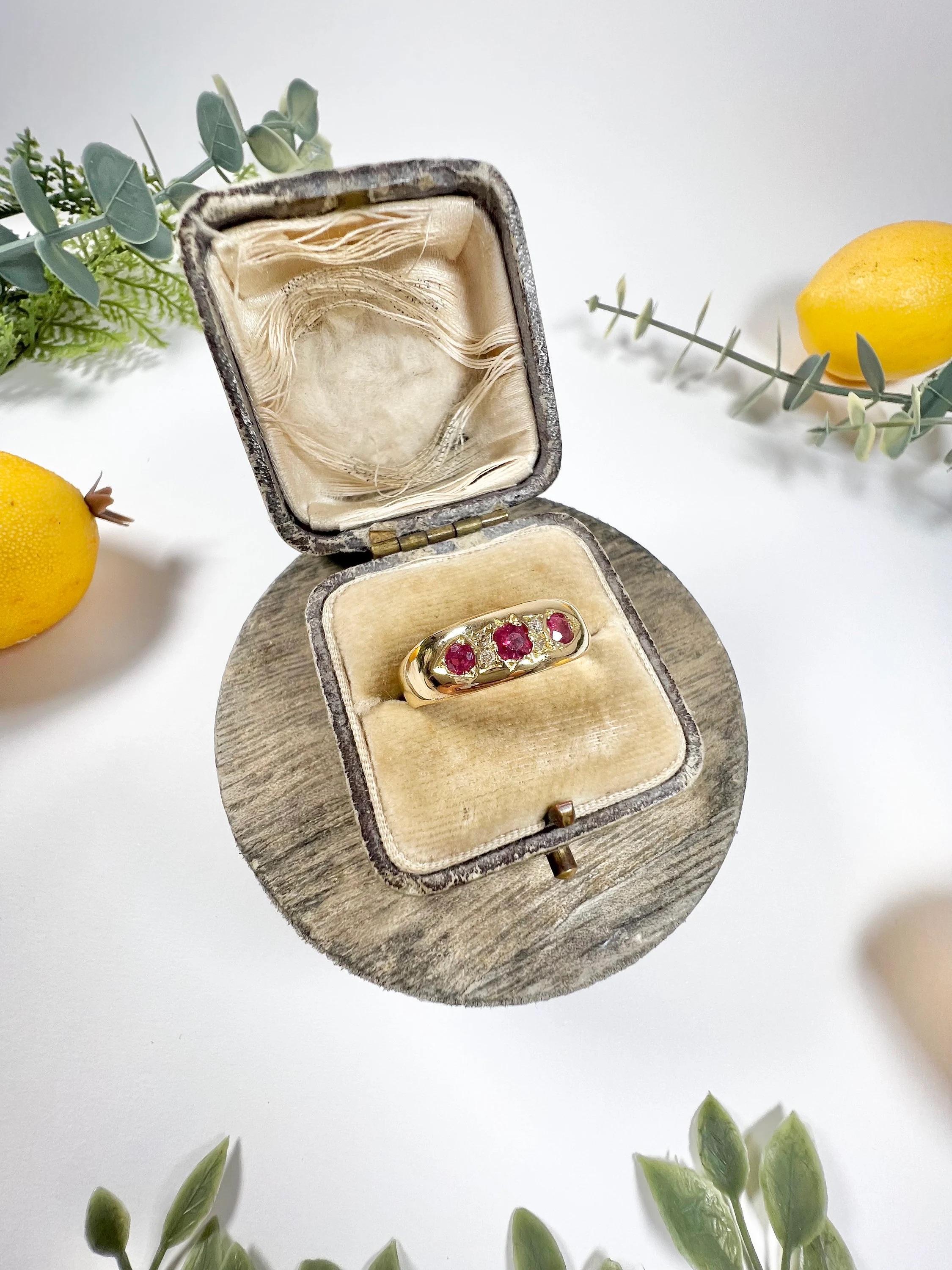 Antique Ruby & Diamond Ring 

18ct Yellow Gold Stamped 

Circa 1900

Fabulous, Edwardian Gold band. set with three gorgeous, natural rubies with little diamond accents in between. Mounted in a lovely, 18ct yellow gold, slightly tapered band. 

Band