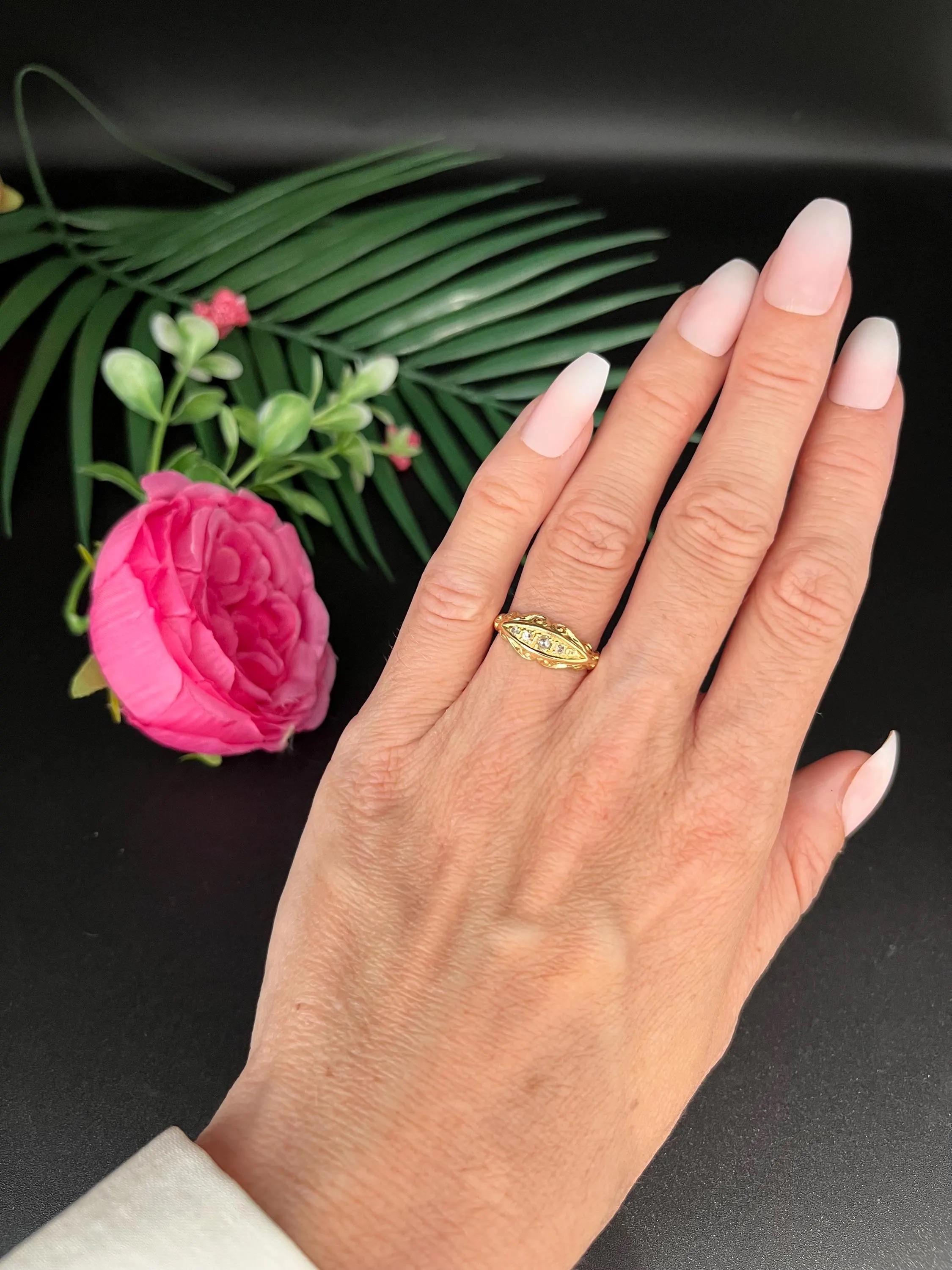 Antique Diamond Ring

A solid 18ct yellow gold ring, set with five old cut diamonds flush into the surface of the band. The stones graduate subtly in size, with the largest at center, creating a balanced, symmetrical look.

The ring features a fully