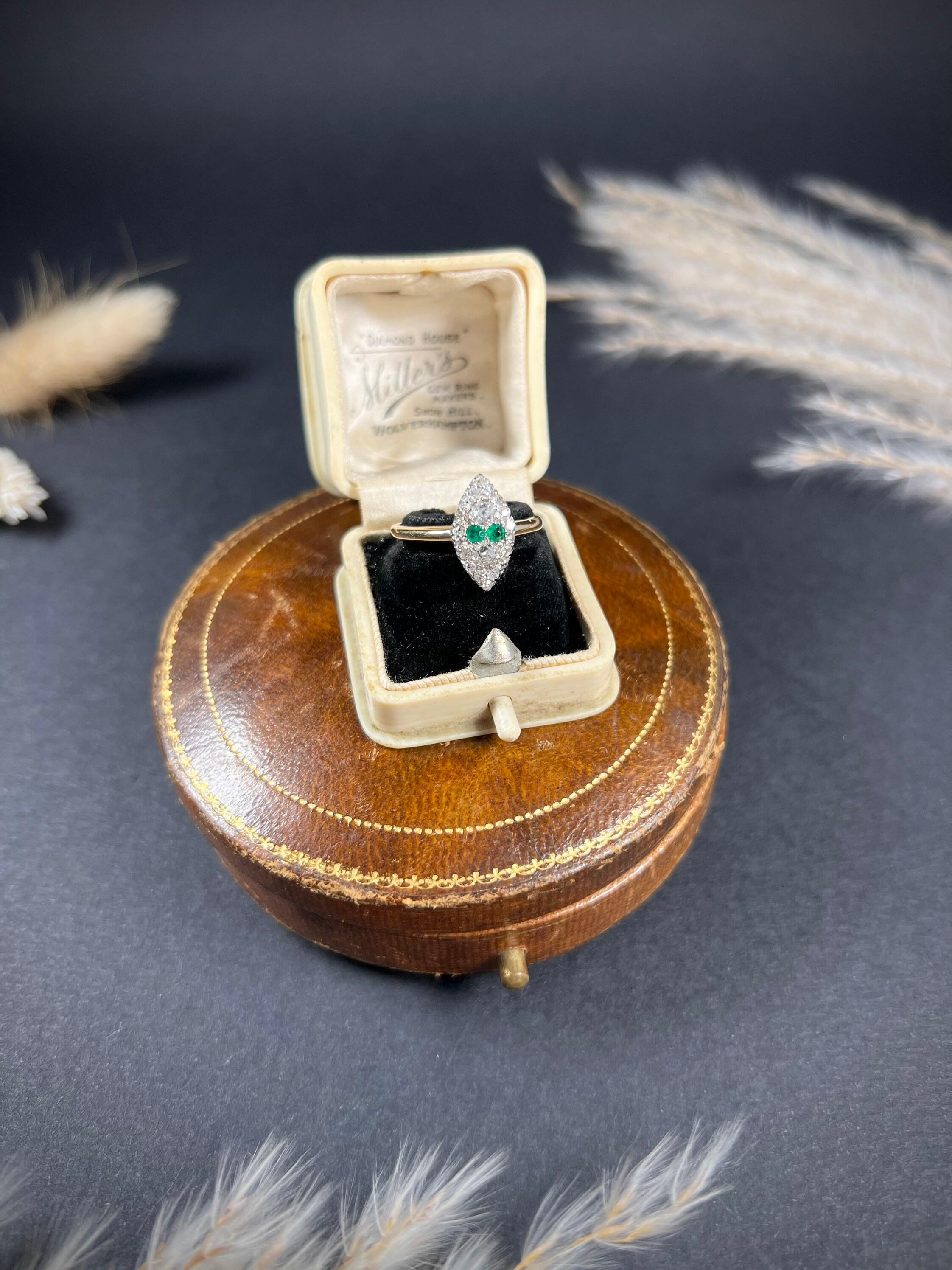 Antique Emerald Marquise Ring 

18ct Gold Stamped 

Hallmarked Chester 1903

Makers Mark A & R

Fabulous, Edwardian marquise/navette shaped ring. Set with two gorgeous, natural emeralds & two sparkling white diamonds to the centre. Framed