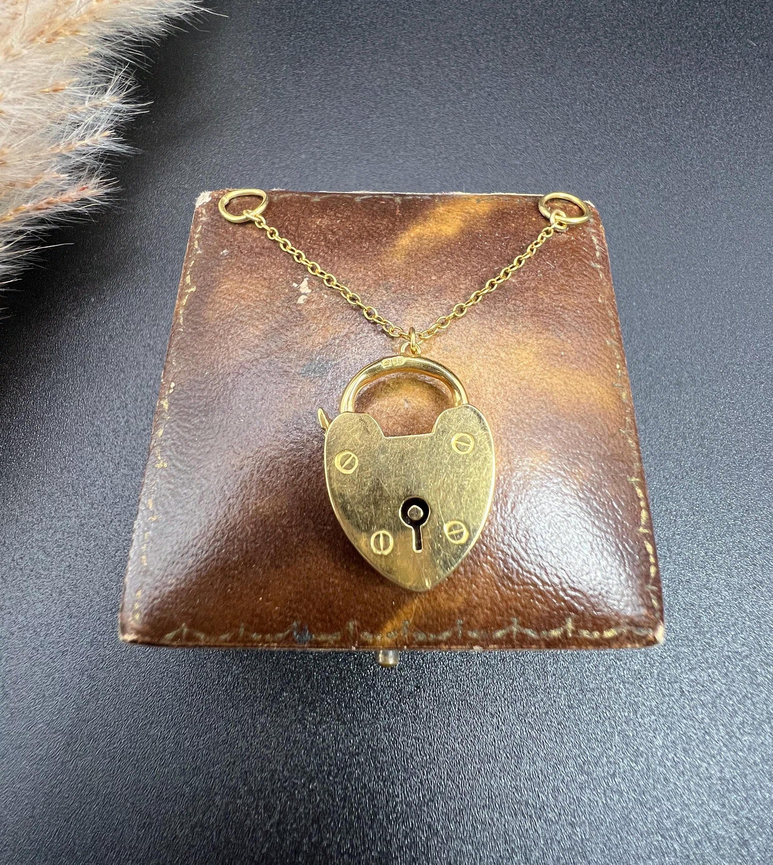 Antique Gold Padlock

18ct Yellow Gold 

Hallmarked London 1908

Makers Mark E C 


This stunning Antique heart padlock is crafted from 18ct yellow gold and suspended from a length of trace link chain with a jump ring at each end. The back of the