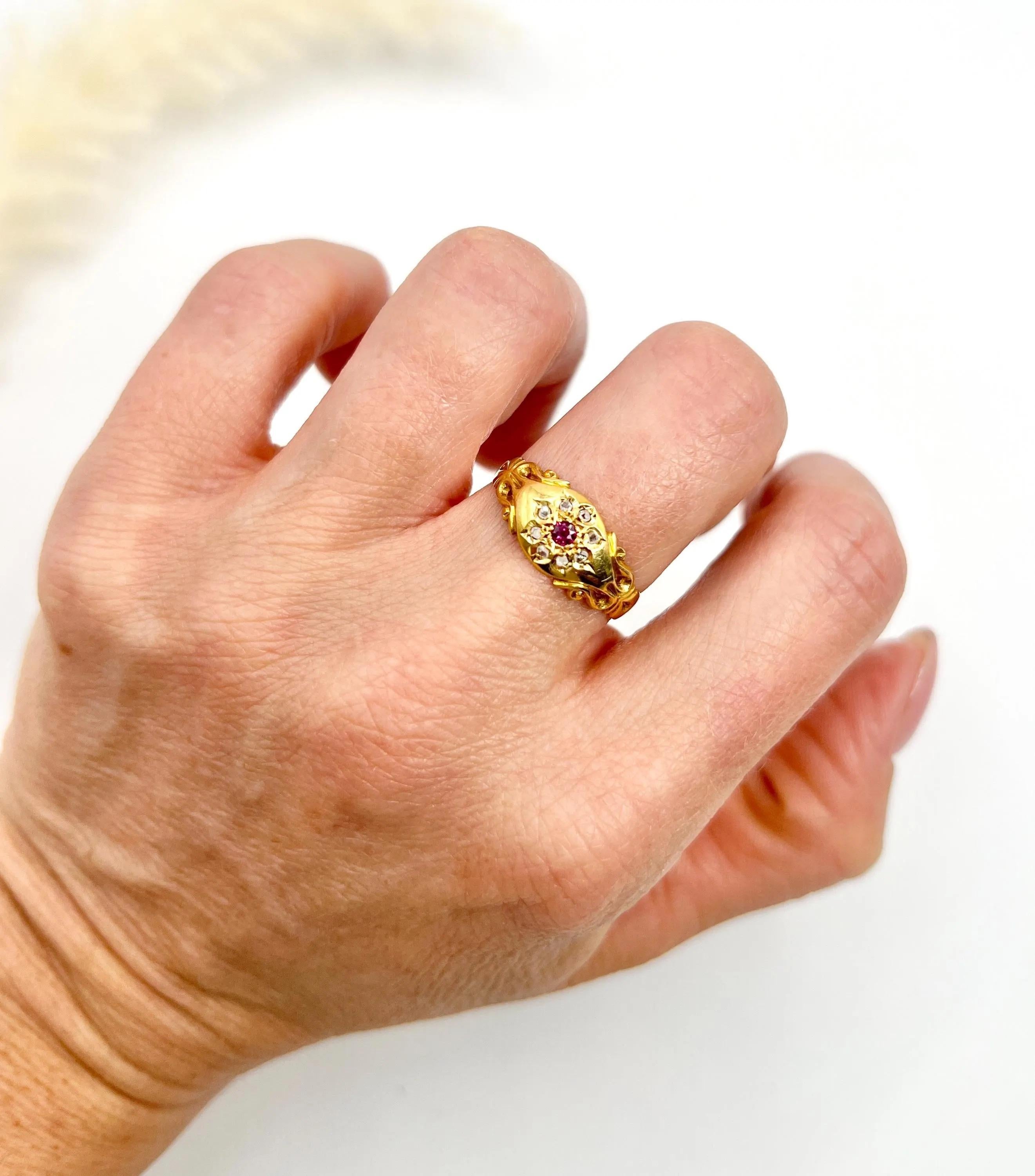 Antique Ring 

18ct Gold

Hallmarked London Chester 1904

Step back in time with this stunning Edwardian tdaisy gypsy ring, crafted from radiant 18ct yellow gold. This exquisite piece showcases a vibrant natural ruby in the centre, surrounded by