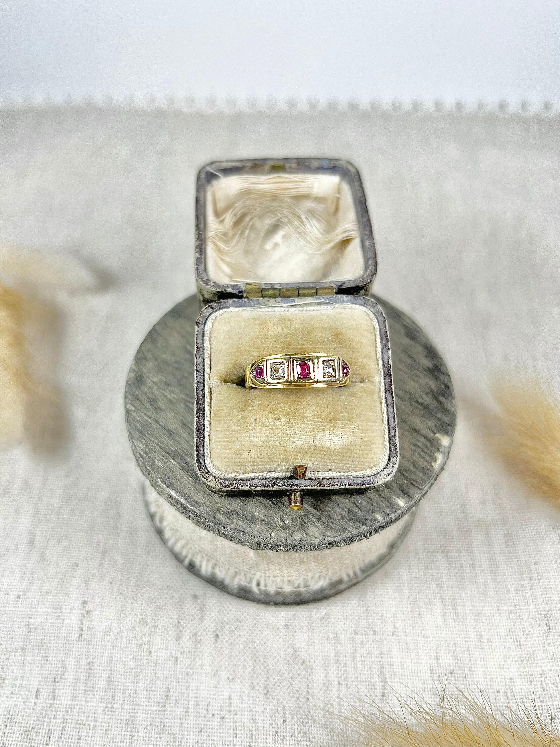 Antique Ruby & Diamond Ring 

18ct Gold Stamped 

Circa 1900

Lovely, Edwardian gold band style ring. Set with alternating, natural rubies & diamonds. The centre stones in pretty square settings & the ends in lovely triangular shapes. 

The face of