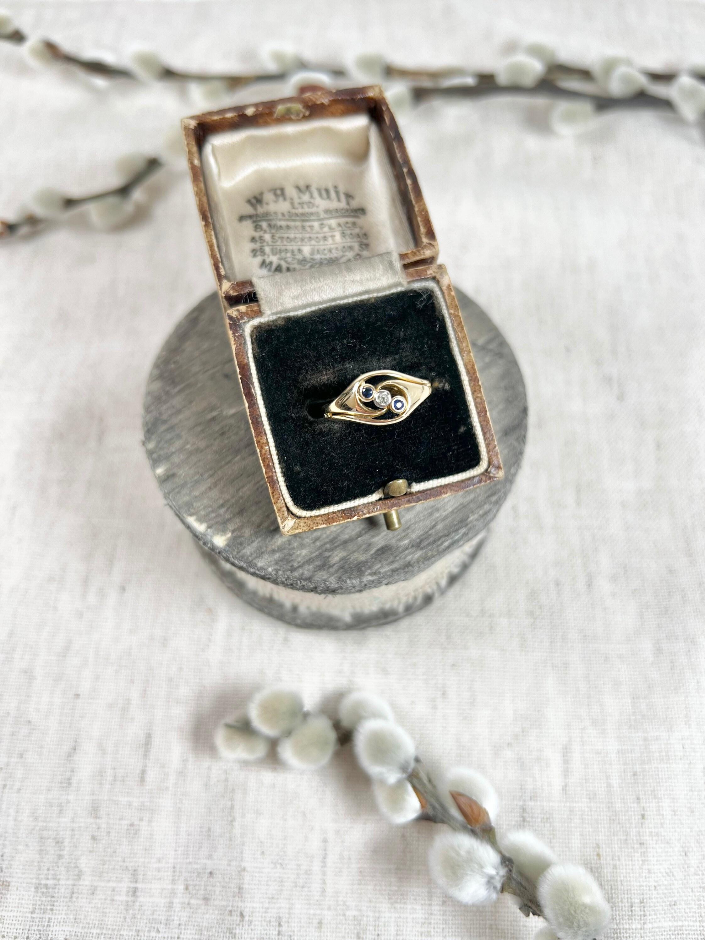 Antique Sapphire & Diamond Ring 

18ct Gold 

Makers Mark H W Ltd

Pretty, Edwardian three stone ring. Set with a centre diamond & two natural sapphire stones- mounted diagonally on a lovely crossover, 18ct gold band. 

Height of the ring measures