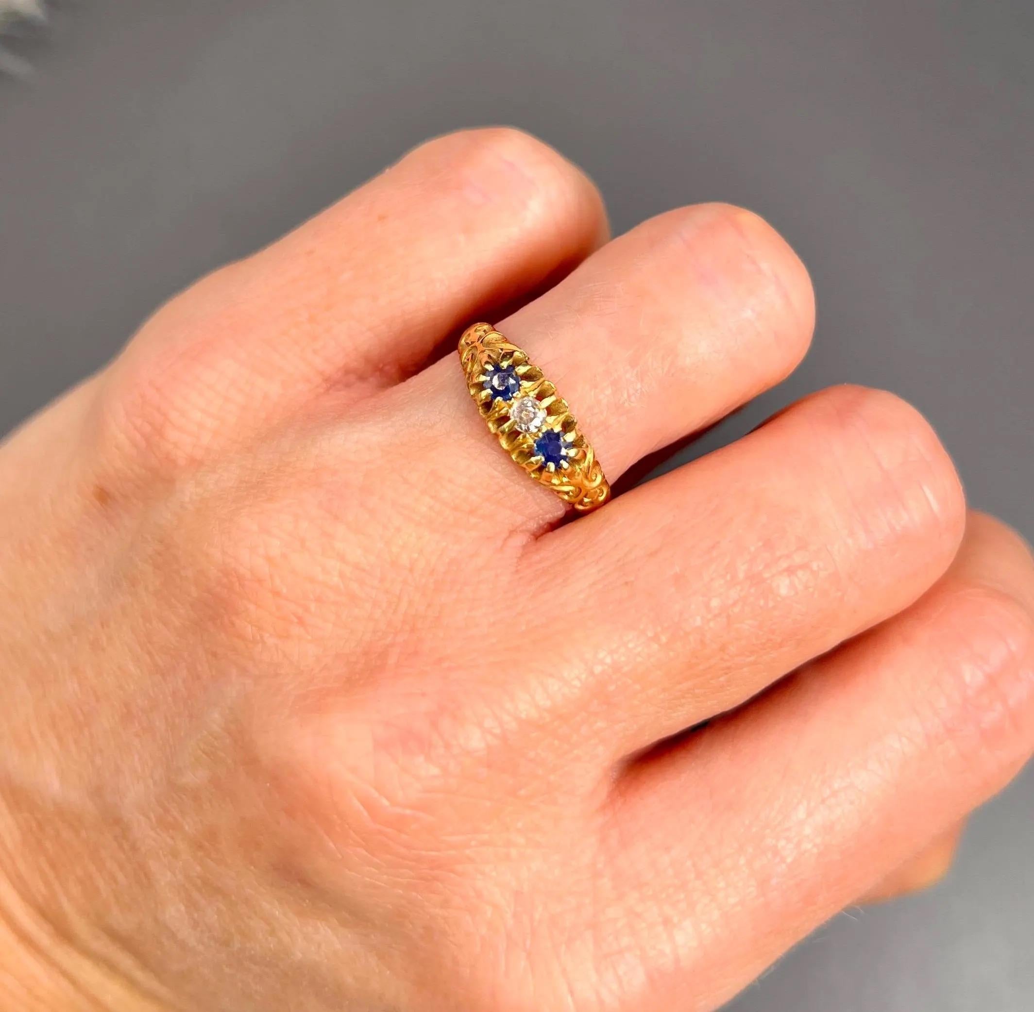 Antique Gypsy Ring 

18ct Gold Stamped

Hallmarked Birmingham 1906

Makers Mark C Br

Introducing a stunning 18ct yellow gold Edwardian three-stone ring. This exquisite piece features a centre, natural diamond flanked by two beautiful blue natural