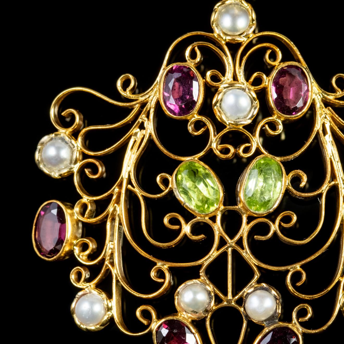 A fabulous antique Edwardian Suffragette pendant decorated with Peridots, Almandine Garnets and Pearls with a Pearl dropper hanging below. 

Suffragette jewellery was worn to show one’s allegiance to the women’s Suffragette movement in the early