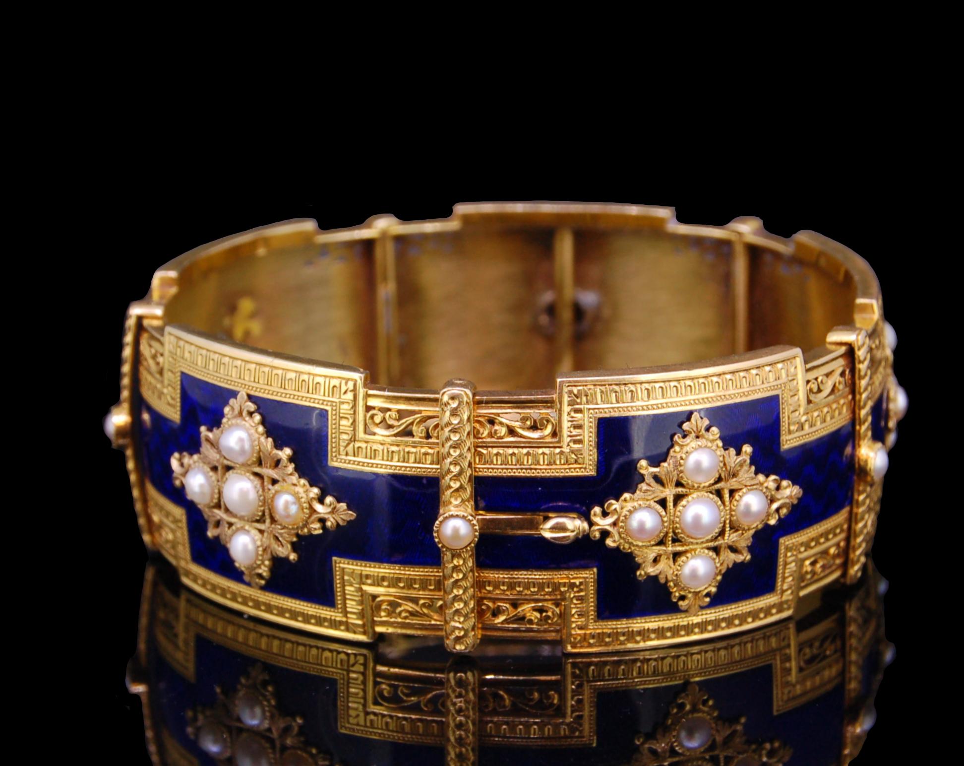 ANTIQUE 18ct GOLD, ENAMEL AND PEARL BANGLE BRACELET, the mid section decorated with blue enamel, set with star shaped openwork appliques set with pearls, the appliques alternated with vertical bands set with a pearl. The sides of the bracelet with