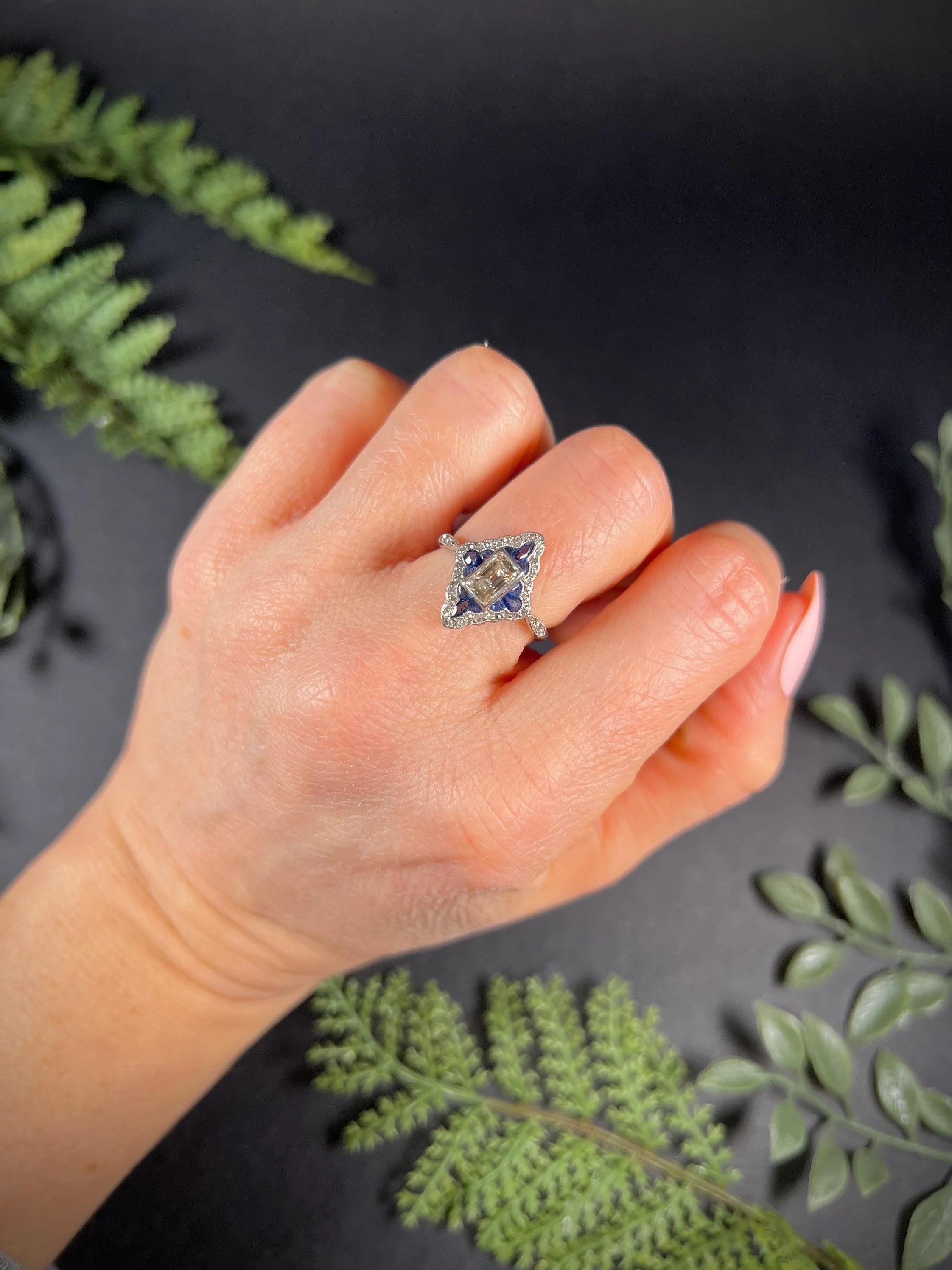 Antique Deco Ring 

18ct Gold & Platinum Tested 

Circa 1920’s

Fabulous, original Art Deco ring. Set with a gorgeous, natural, emerald cut centre diamond. Surrounding this- beautiful, natural sapphires & old cut natural diamonds forming a rounded,