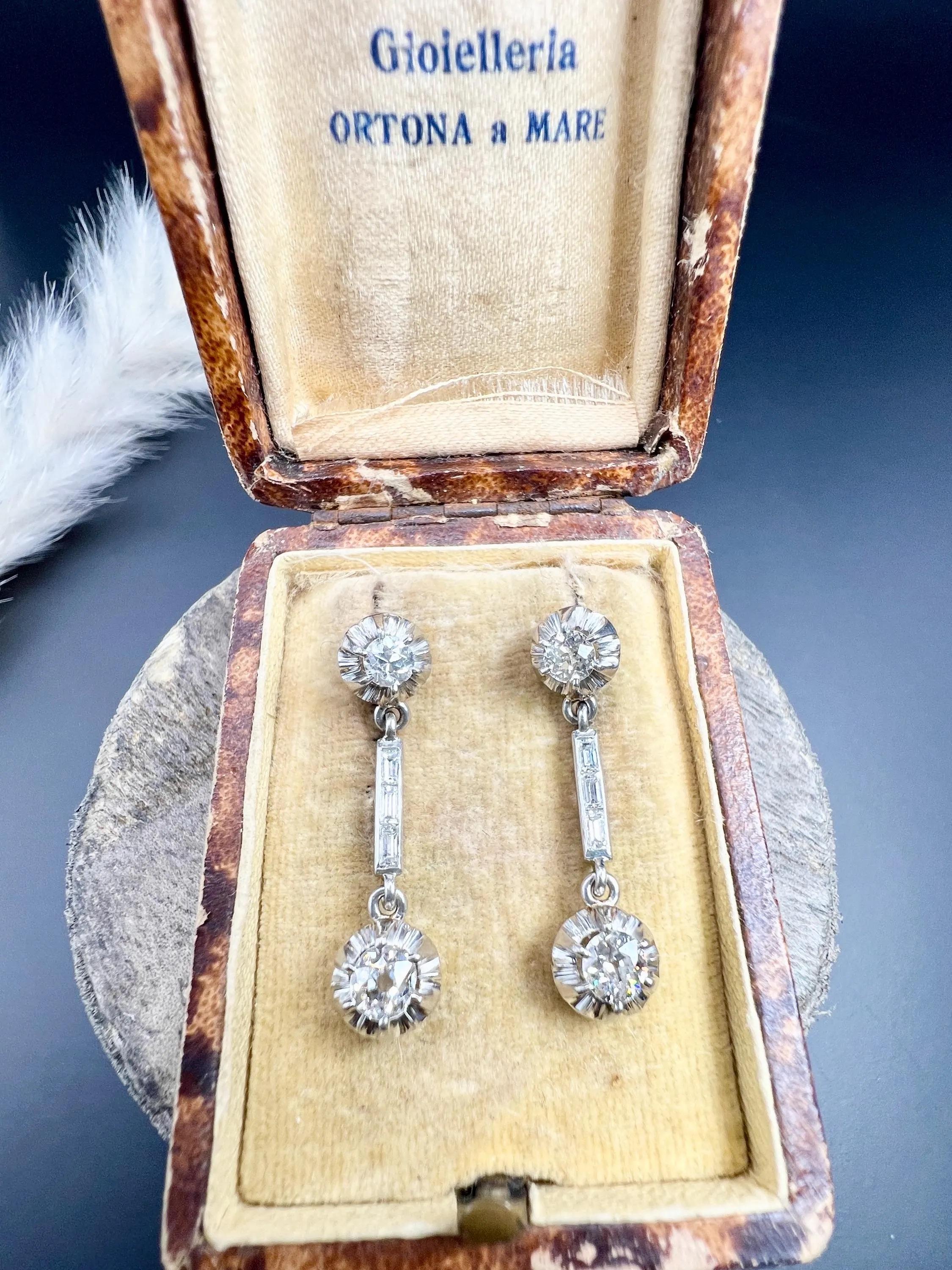 Antique Diamond Earrings 

18ct Yellow Gold & Platinum Tested

Circa 1920s

These stunning drop-style earrings radiate classic charm with elegant long stems featuring diamonds set in platinum dormeuse casings at both the top and bottom. The design