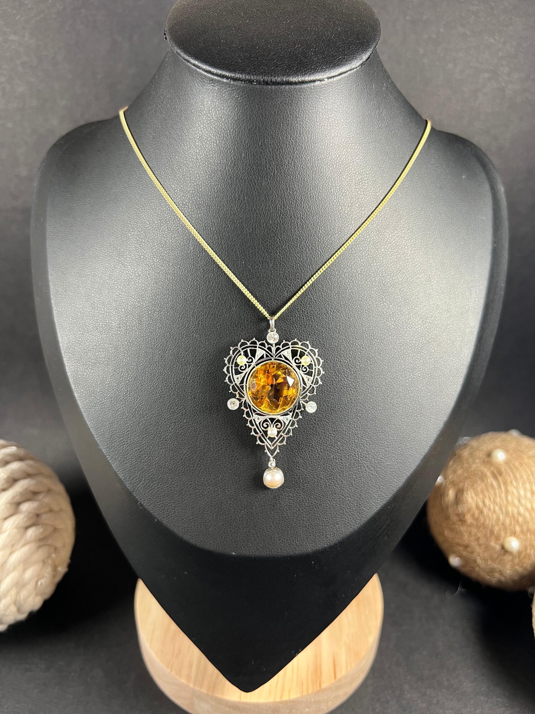 Antique Citrine Necklace 

18ct Gold & Platinum Tested

Circa 1900

This exquisite Edwardian pendant is a perfect blend of vintage charm and contemporary elegance. Crafted with 18ct gold and platinum, this pendant features a large, round-faceted