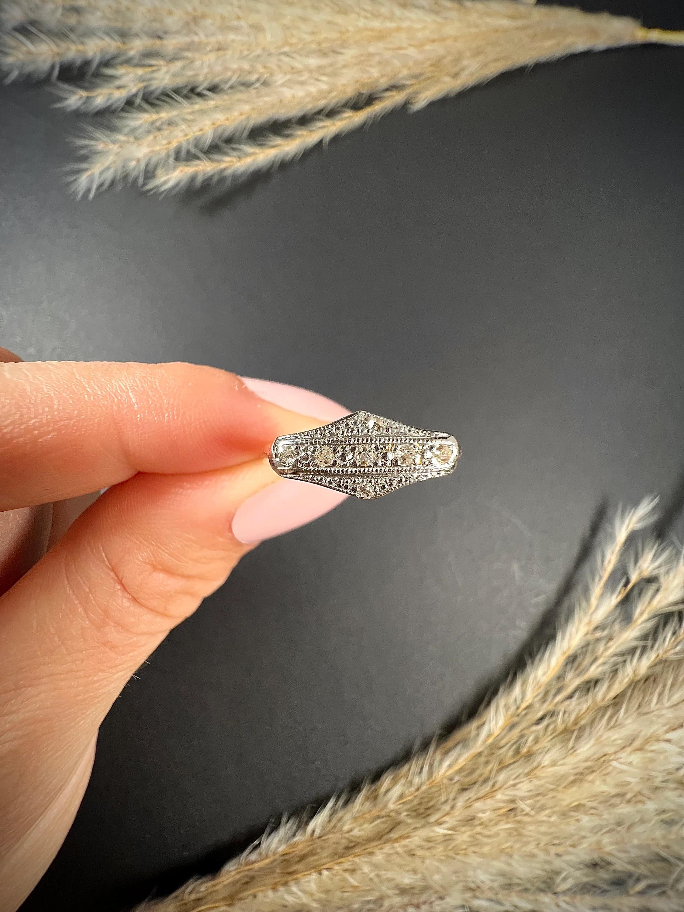 Antique Diamond Ring 

18ct Gold & Platinum Stamped 

Circa 1910

Pretty, little post Edwardian era ring. Set with a total of seven little diamonds in a pretty, platinum, illusion setting & mounted on a 2mm yellow gold band. 

Face of the ring