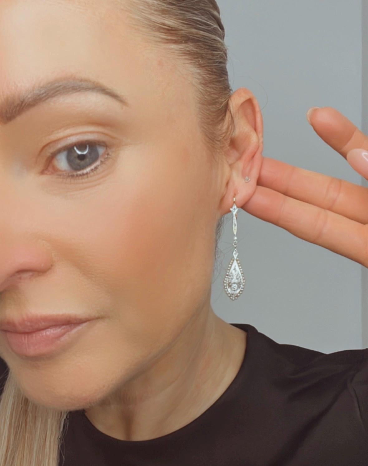 Antique Diamond Drop Earrings 

18ct Gold & Platinum

Circa 1910

Discover a stunning pair of Edwardian-era earrings that encapsulate the elegance and artistry of the time. Fashioned in 18ct gold, these fabulous dangle earrings feature a captivating