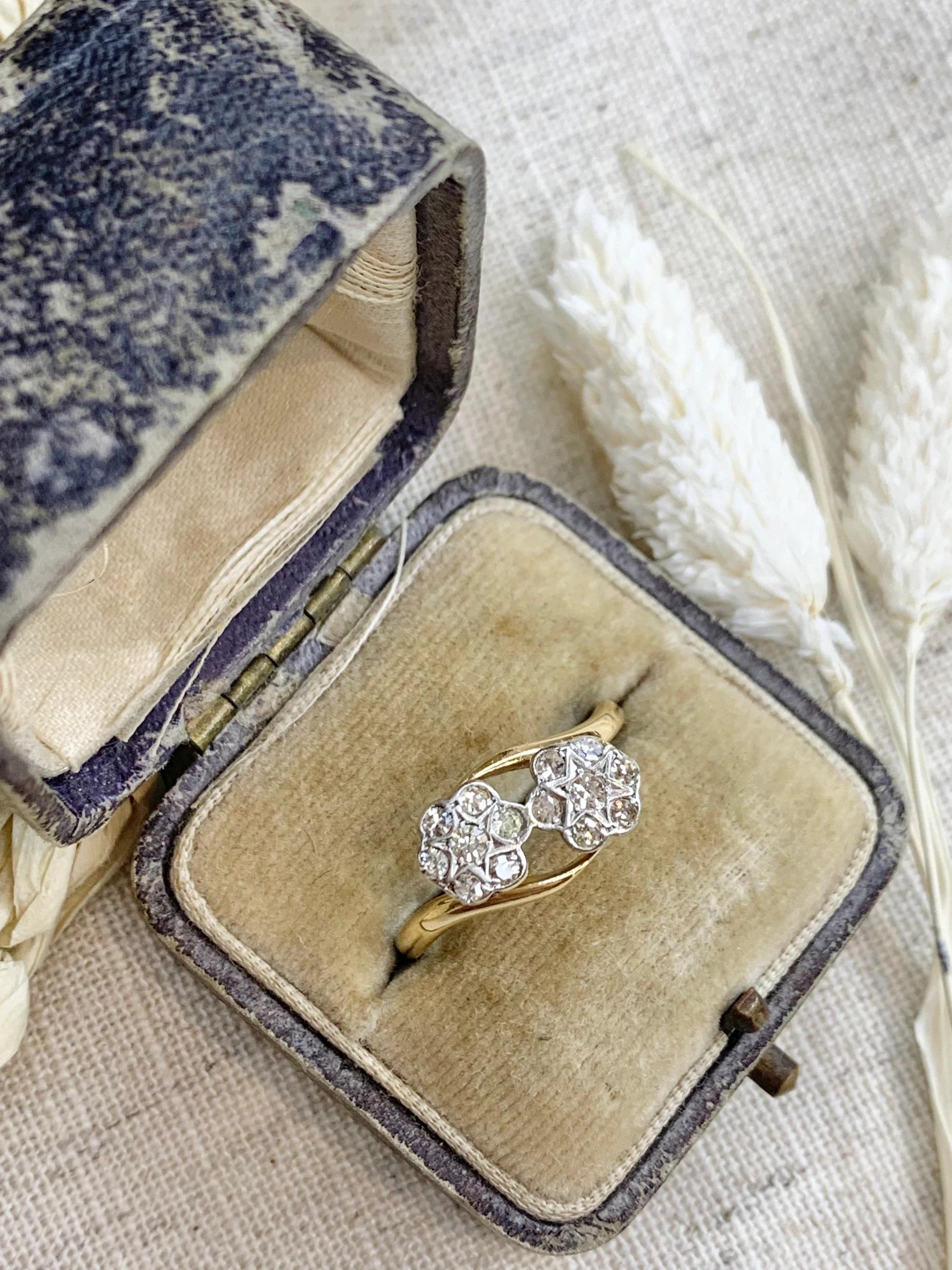 Double Diamond Daisy Ring

18ct Gold & Platinum 

Edwardian Circa 1900

Fantastic Double Daisy Each Flower Containing Seven Diamonds Creating a Gorgeous Centre Star

Makers Mark HS & Stamped 18ct

UK Size Q

US Size 8 1/2

Can be resized using our