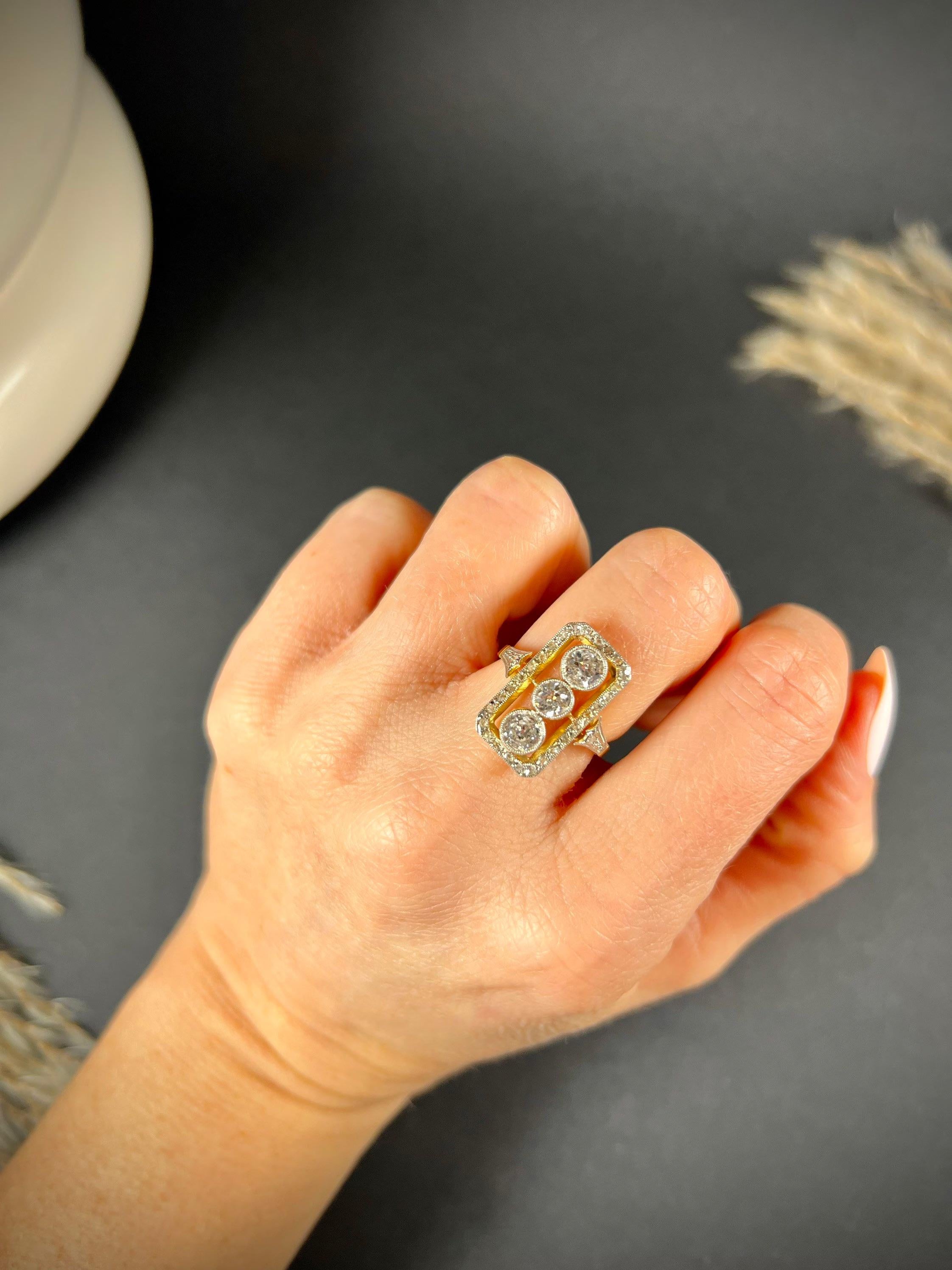 Antique Diamond Ring 

18ct Yellow Gold & Platinum Tested 

Circa 1900

Fabulous, Edwardian diamond ring. Set with three centre, natural diamonds & rectangular halo of sparkling diamonds. 
Diamonds are set in platinum & mounted on an 18ct yellow