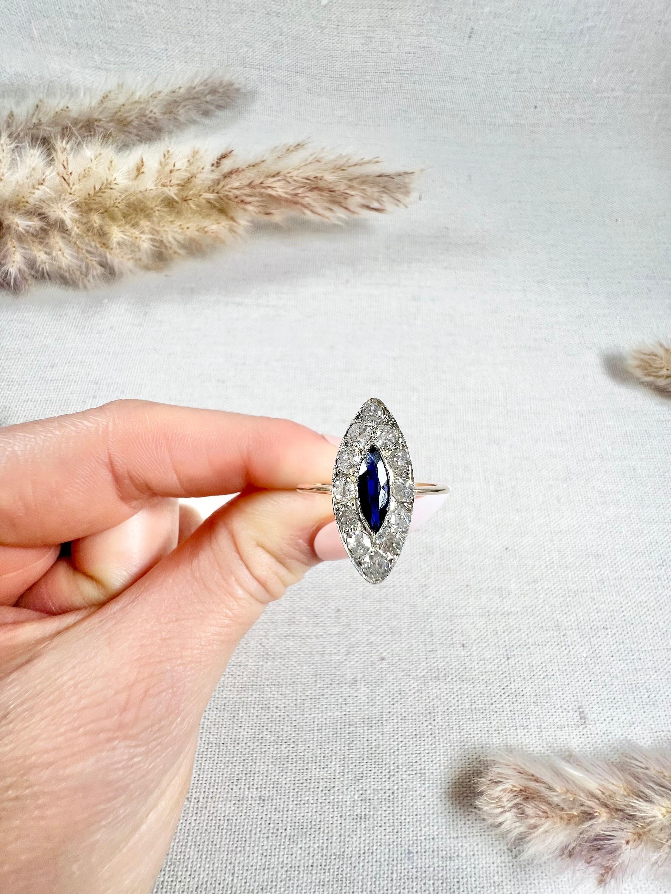 Antique Sapphire & Diamond Marquise Ring

18ct Gold & Platinum Tested 

Circa 1910

This stunning 18ct gold and platinum ring features a marquise-shaped natural sapphire, surrounded by a halo of dazzling natural diamonds. The stones are set in
