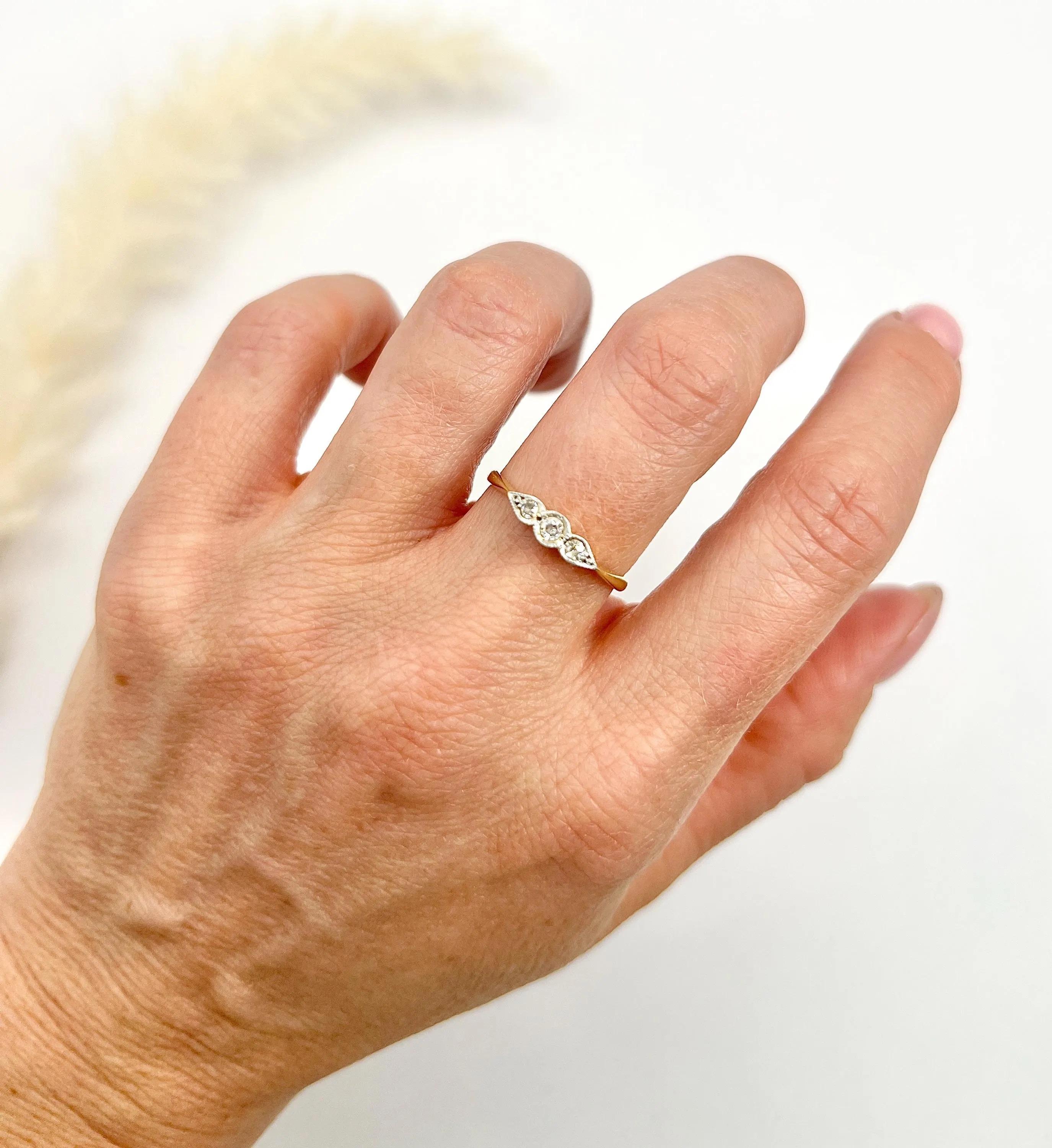 Antique Diamond Ring 

18ct Gold & Platinum Stamped

Circa 1910

Behold this stunning Edwardian-era diamond trilogy ring, a timeless piece exuding elegance and grace. This exquisite ring features three enchanting, natural diamonds nestled in