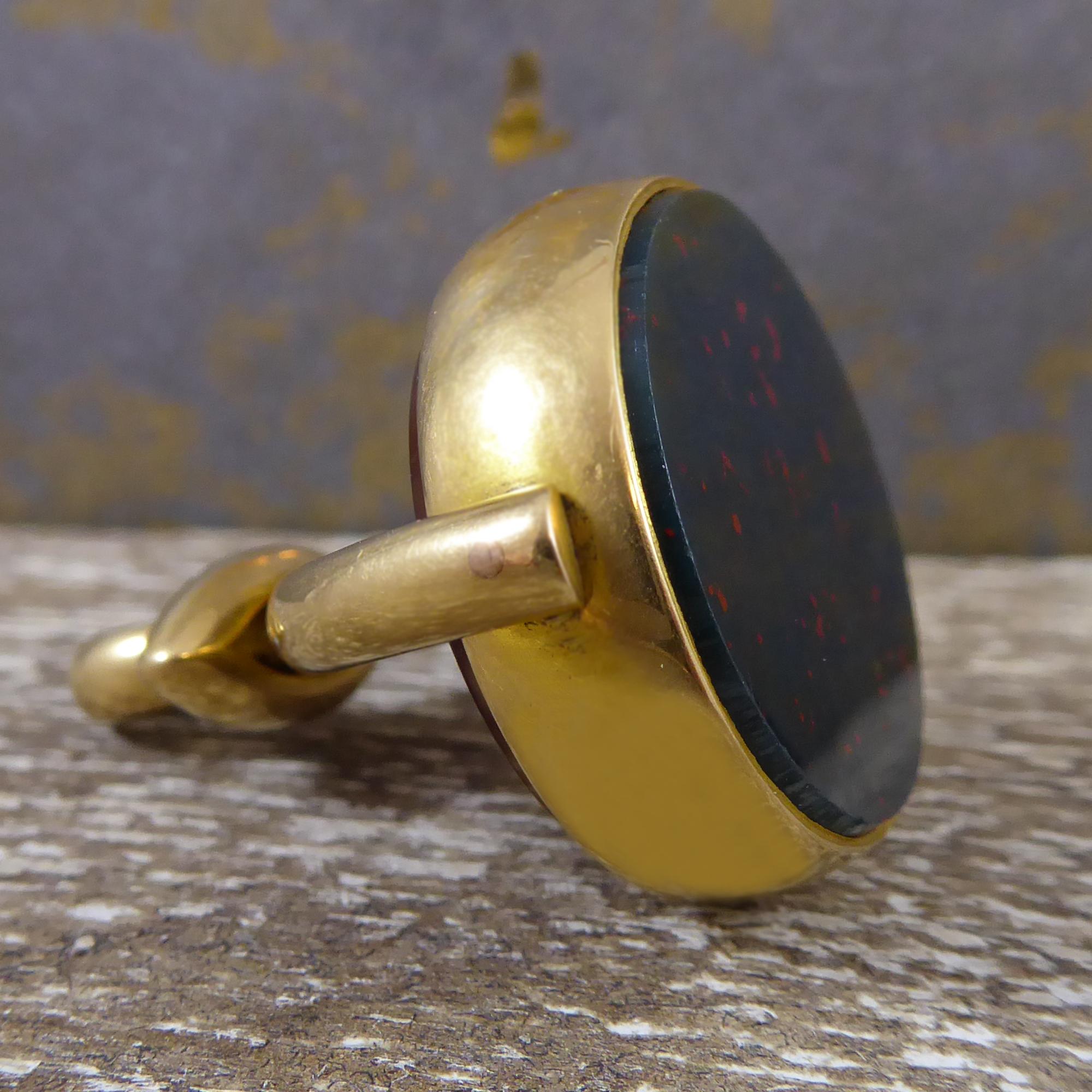 A fabulous spinner fob dating from Victorian England and dated 1899 from the Birmingham Assay Office. In a substantial and bold design which only gains in stature by its simplicity, the fob is mounted on one side with a circular slab of cornelian