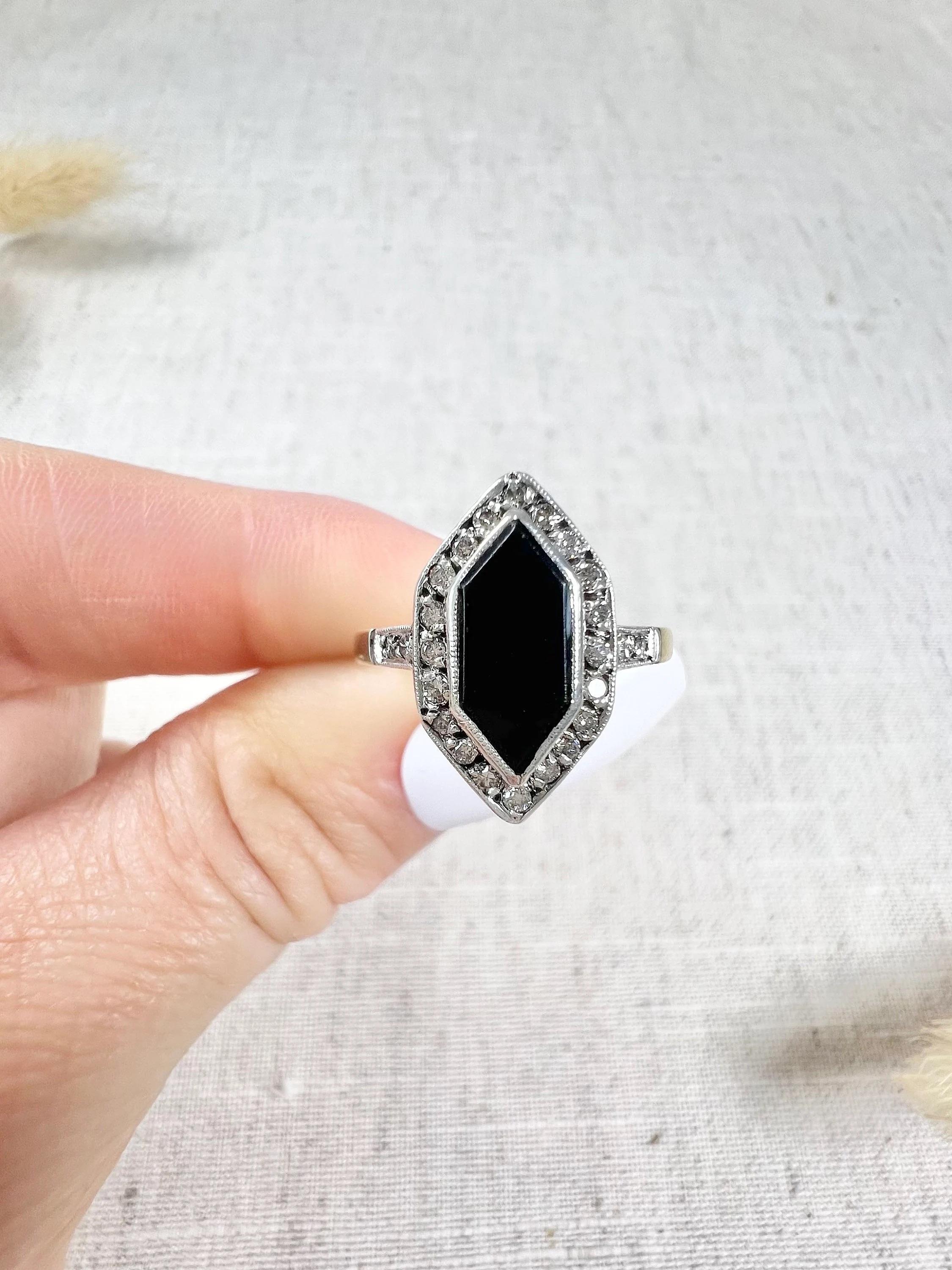 Antique Onyx & Diamond Ring

18ct Yellow & White Gold Stamped

This stunning 1920s ring is a true masterpiece of fine jewellery craftsmanship. Made of 18ct yellow gold, it features a marquise-shaped design that is both elegant and timeless. The