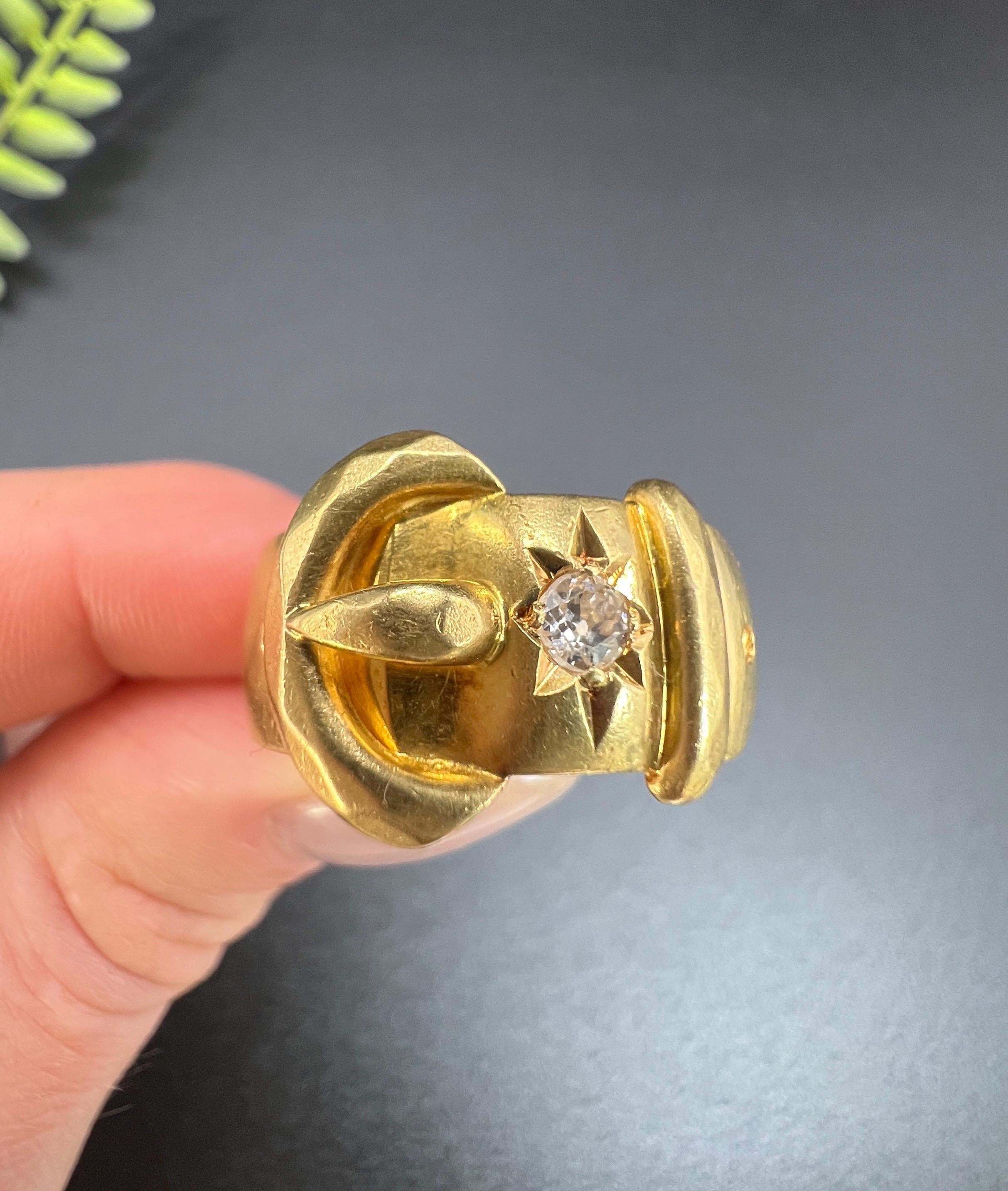 Antique Buckle Ring 

18ct Yellow Gold

Hallmarked London 1915

Makers Mark A M 

This antique gold buckle ring is a timeless piece of jewellery that symbolises everlasting love, fidelity, and loyalty. It features a star-set natural diamond, and the