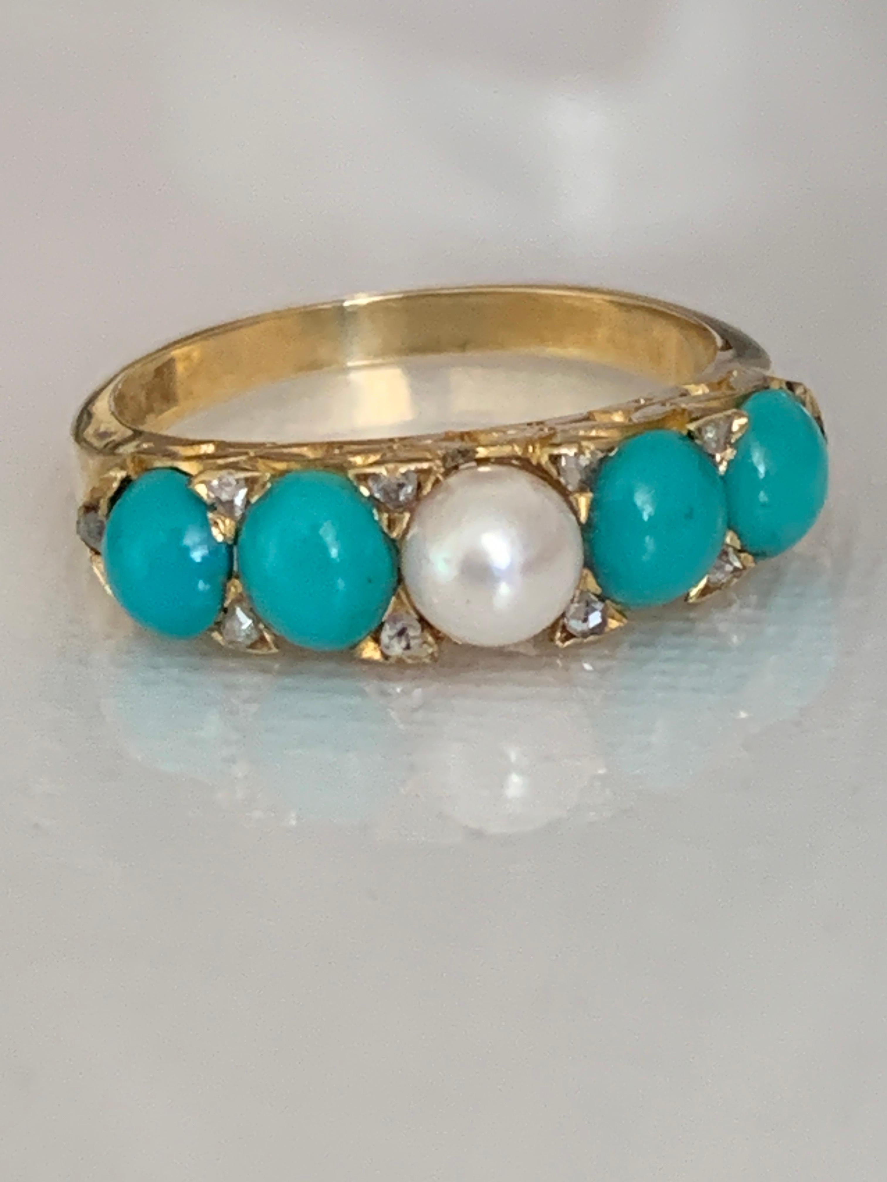 Antique 
18ct 750 Gold Ring
with Central Pearl and Turquoise Cabochons either
side with Old Mine Cut diamonds in between
each diamond measures approx. 1,5 mm Diameter
amounting to 10 x 0.015 = 0.15 Carats
Size  U.K  - M
Stamped 18ct inside band