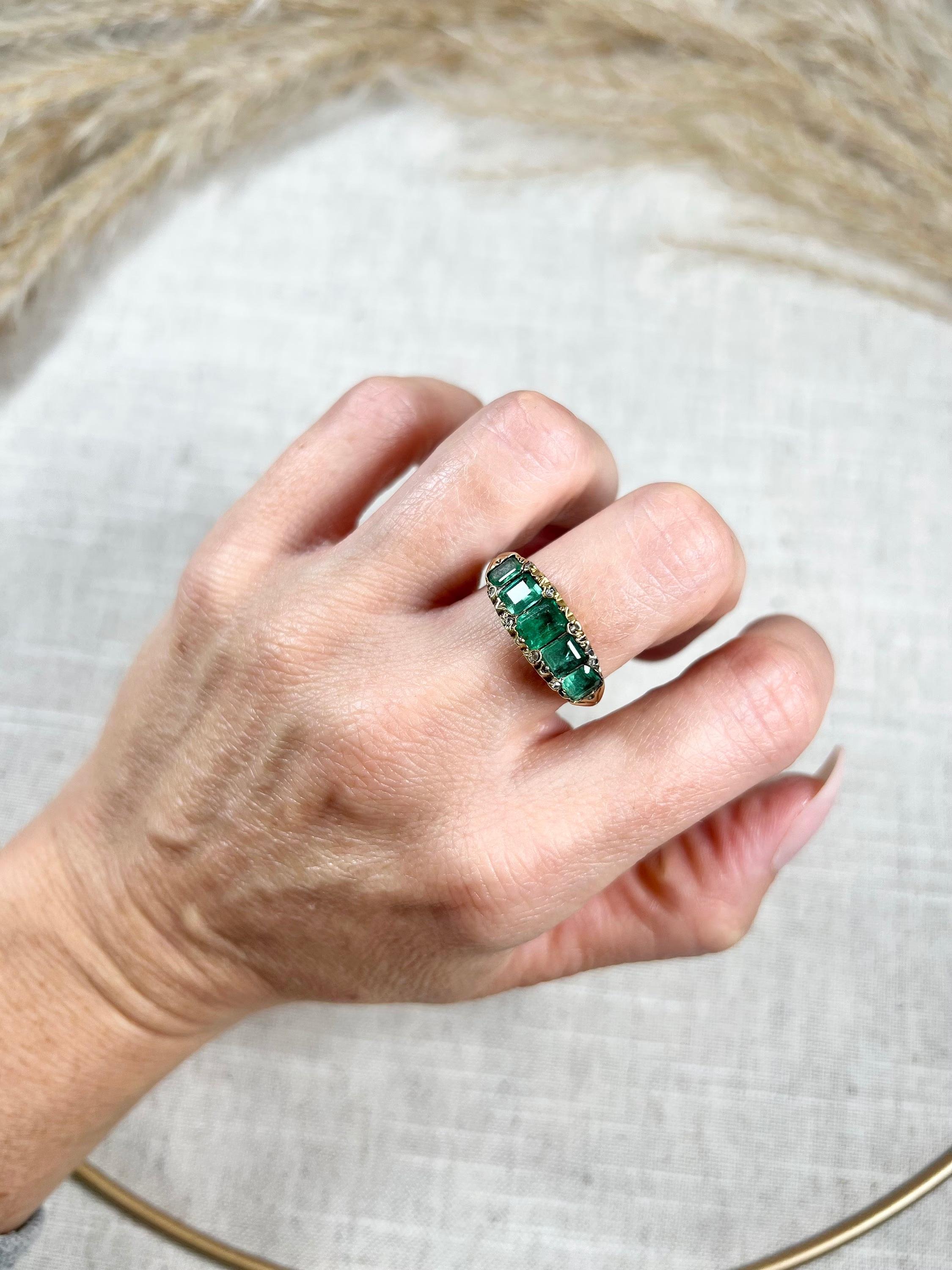 Antique Emerald Ring 

18ct Gold Tested 

Circa 1870s

This stunning Victorian-era ring features five beautiful natural emeralds set in an 18ct gold carved setting, with sparkling diamonds accents. Dating back to the 1800s, this piece showcases the