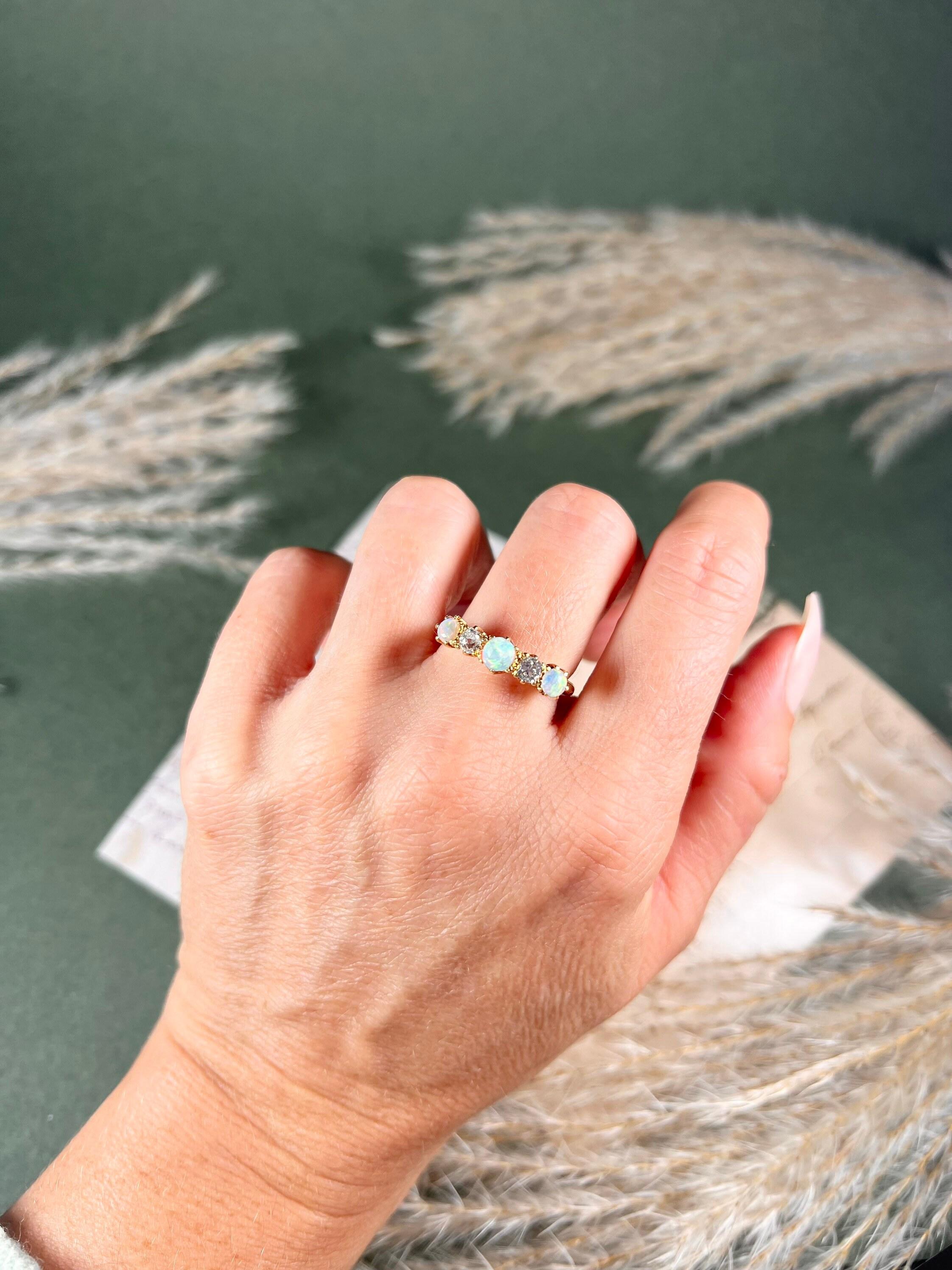 Antique Opal & Diamond Ring 

18ct Gold 

Circa 1890

Gorgeous, Victorian five stone ring. Set with beautiful round fiery opals & old cut diamonds. 
A super pretty ring for your collection. 

Measures approx height 5.5mm & width 20mm

UK Size Q