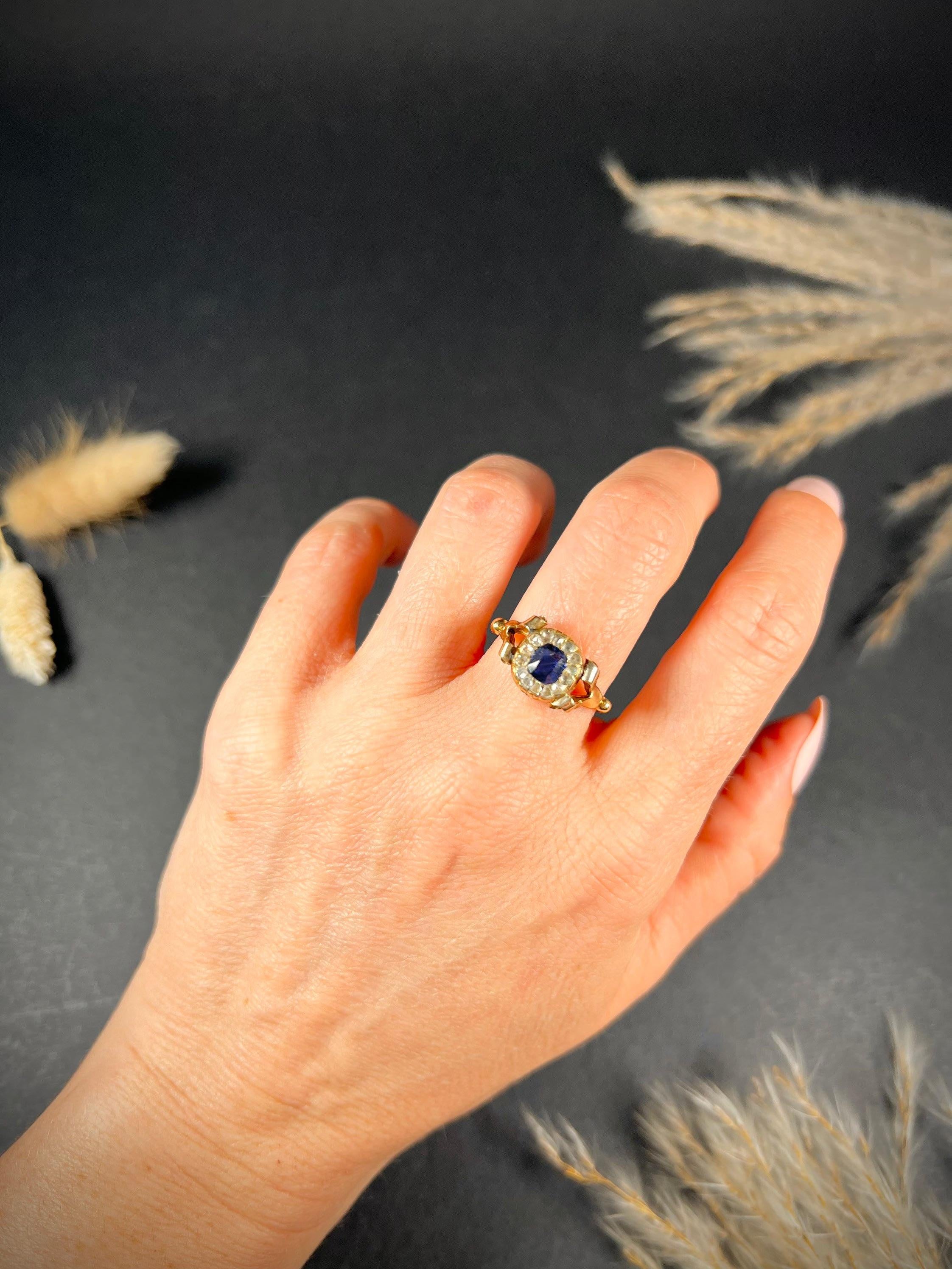 Antique Sapphire Cluster Ring 

18ct Gold Tested 

Circa 1880

Beautiful, Victorian cluster ring. Set with a gorgeous, cushion cut, natural sapphire centre. Surrounded by a cluster of natural, old cut diamonds. Mounted in a fancy yellow gold setting