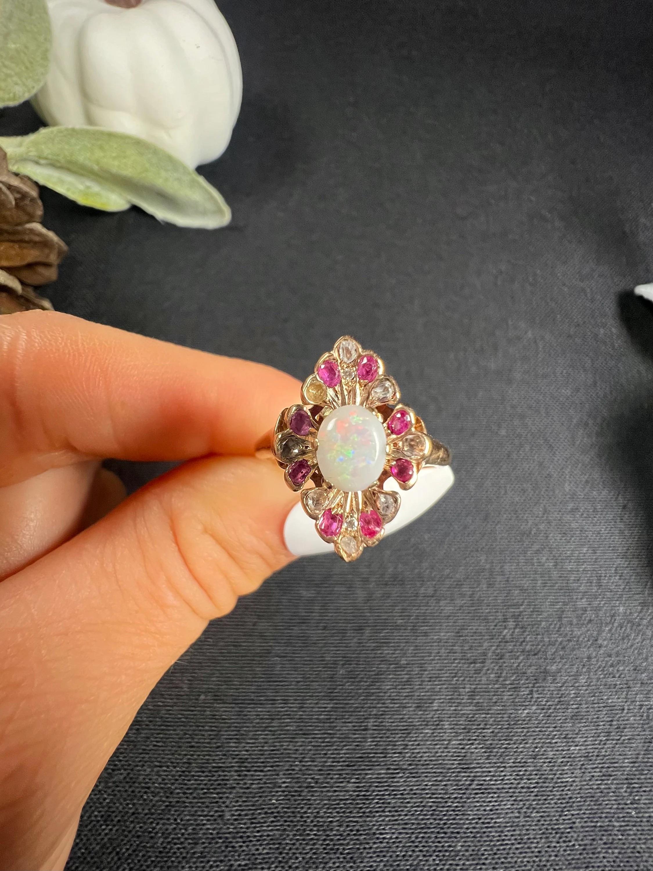 Antique Opal Marquise Ring

18ct Rose Gold Tested

Circa 1880s

This Victorian ring, made of 18ct rose gold, is a true work of art. The stunning oval opal centre stone is framed perfectly by four beautiful fans, each set with old-cut diamonds and