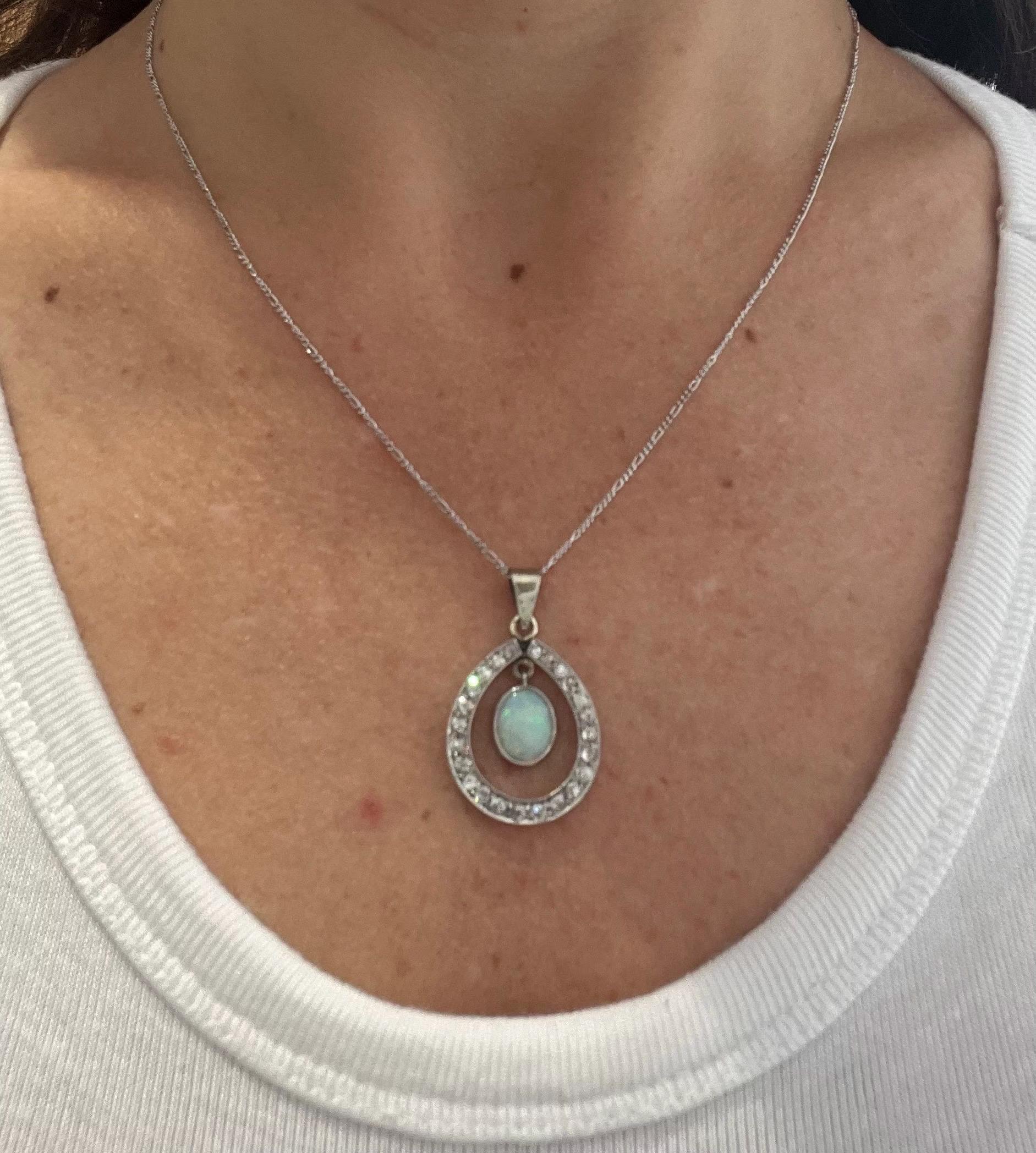 Edwardian Pear-Shaped Opal & Diamond Pendant 

Circa 1910

 THE CHAIN IS SOLD SEPARATELY. 

A captivating piece from the Edwardian era, this antique pendant showcases a luminous oval cabochon opal, surrounded by 24 shimmering old cut diamonds