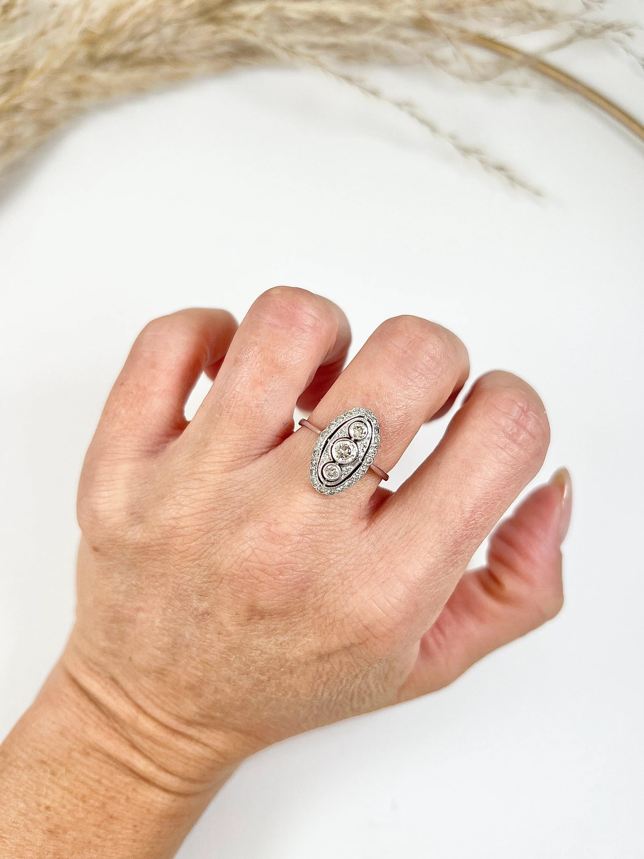 Antique Oval Diamond Ring 

18ct White Gold Stamped 

Circa 1910

Introducing a stunning 18ct white gold Edwardian ring featuring a beautiful oval-shaped three-stone design. This exquisite ring is adorned with sparkling natural diamonds set in