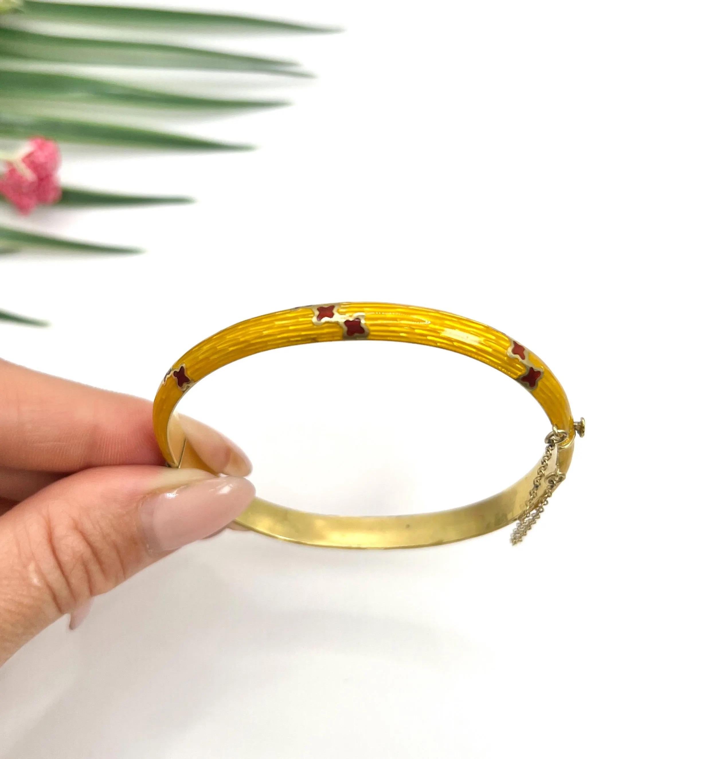 Antique Enamel Bangle 

18ct Gold Yellow

Circa 1920s

Step back in time with this exquisite 18ct gold hinged bangle, a true testament to the elegance of the 1920s. This unique piece features breathtaking yellow guilloche enamel that wraps