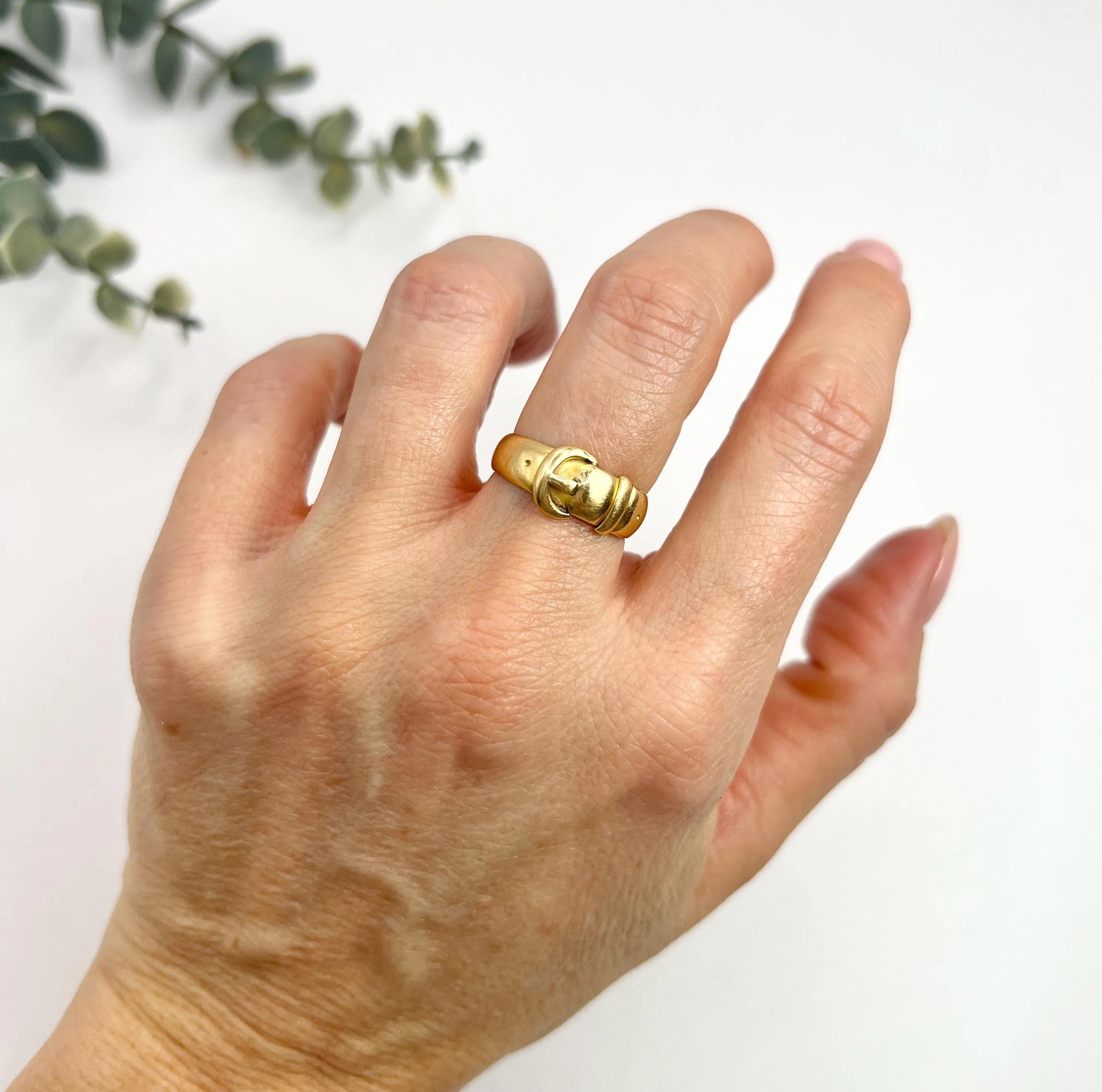 Antique Buckle Ring 

18ct Gold Stamped 

Hallmarked Chester 1920

Makers Mark CyBS

This antique plain gold buckle ring is a timeless piece of jewellery that symbolises everlasting love, fidelity, and loyalty. The buckle on the ring is a