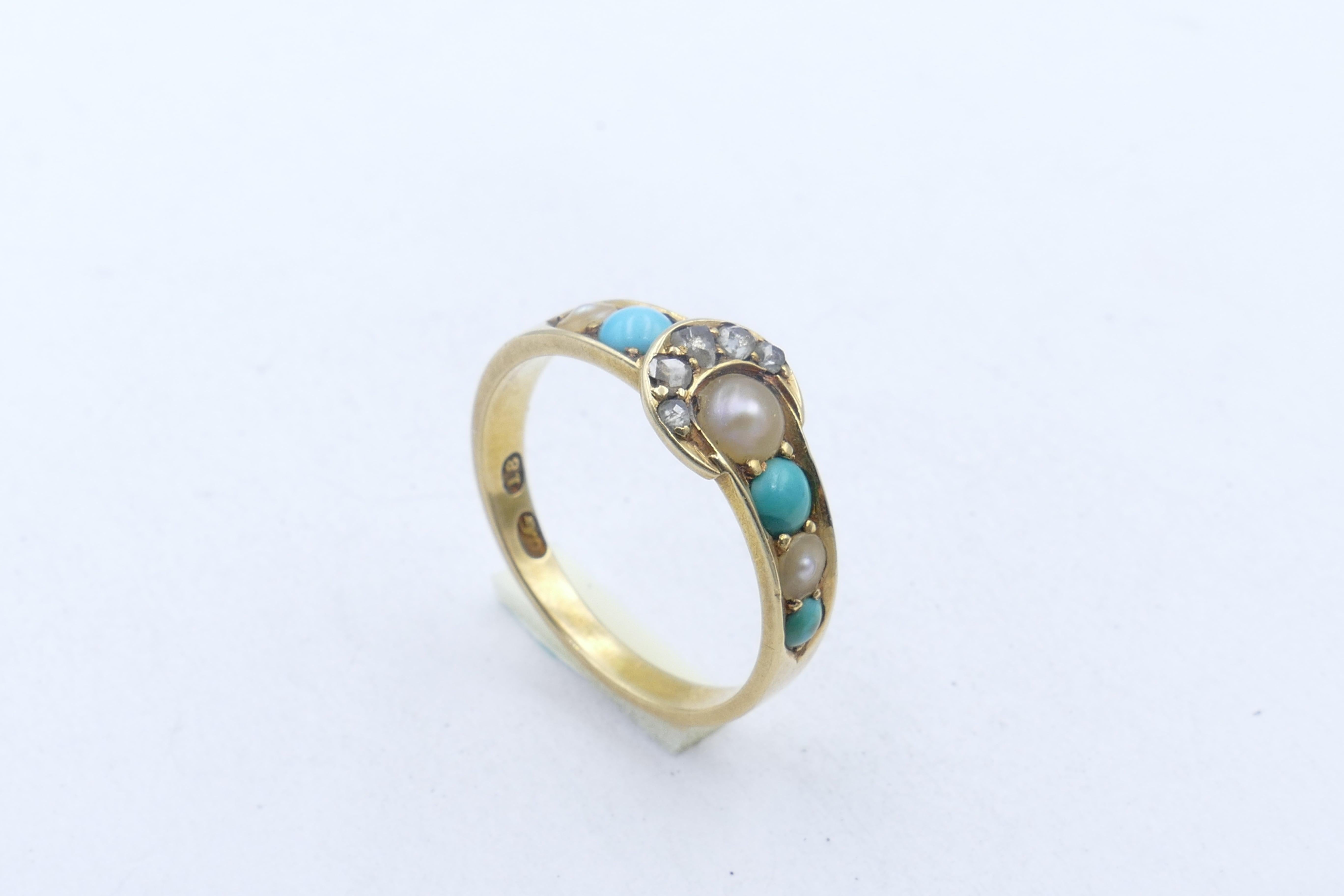 What a fabulous Item of Antiquity this beautifully preserved & very hard to source Buckle Ring is.
5 Rose cut Diamonds are bead set in a horseshoe shape, with 3 Seed Pearls & 3 old Turquoise set along the band.
The Ring is in excellent condition
