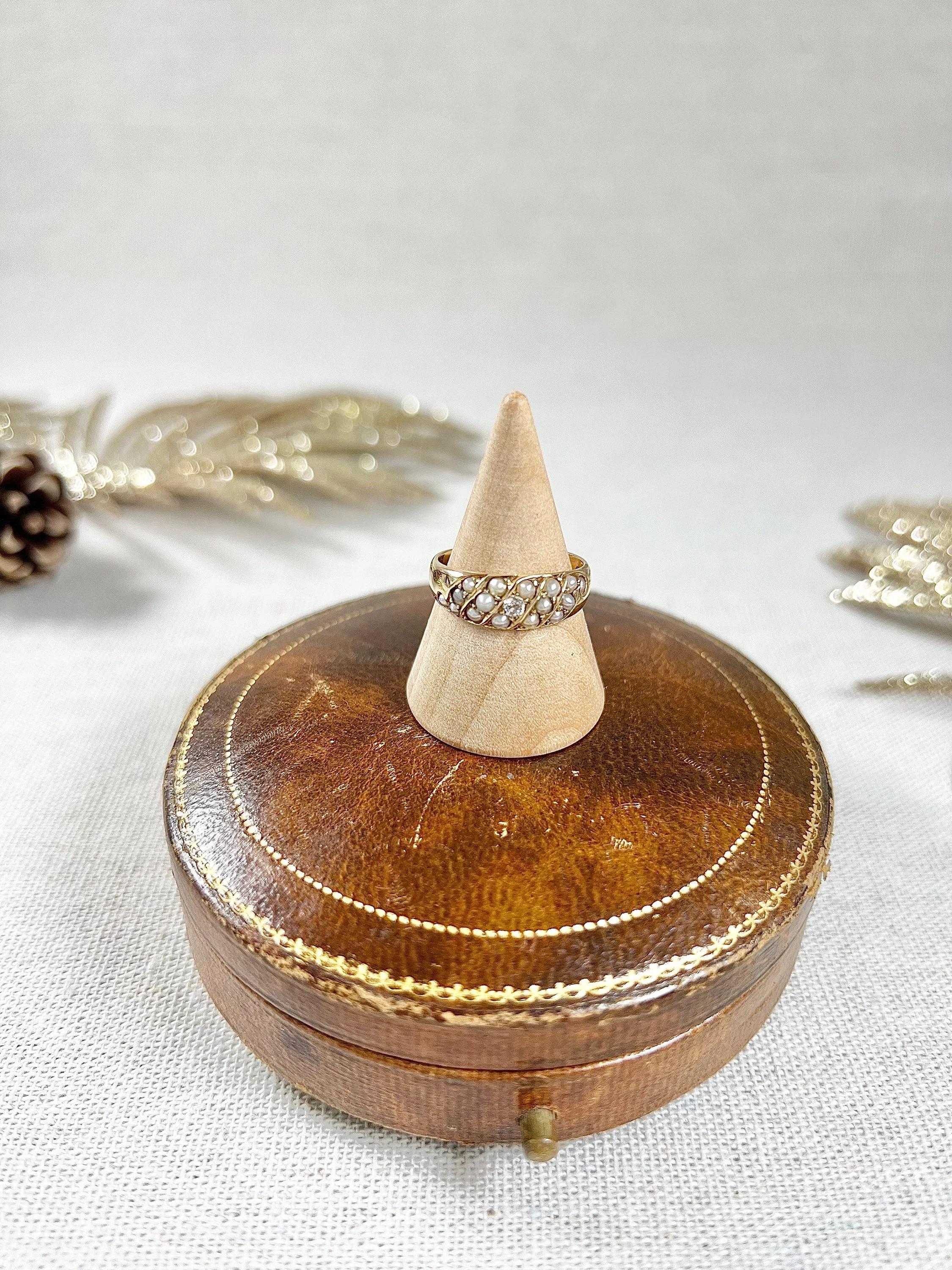 Antique Pearl Band Ring

18ct Gold Stamped

Cirac 1900

Makers Mark J C 

This stunning 18ct yellow gold Edwardian band boasts an elegant design with rows of natural seed pearls placed beautifully along the band, creating an exquisite pattern. The