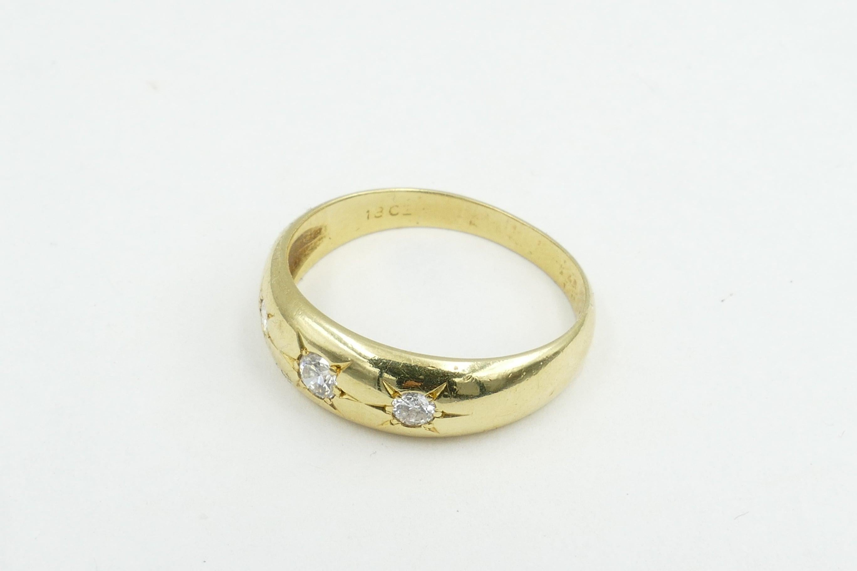 This very lovely old Gypsy Ring set in yellow Gold features 3 high level Diamonds.
The  Colour is F-G & Clarity VS2 - SI1. The Diamond total weight is 0.22cts but they twinkle very brightly.
The Band is polished, half round, reverse tapered to a