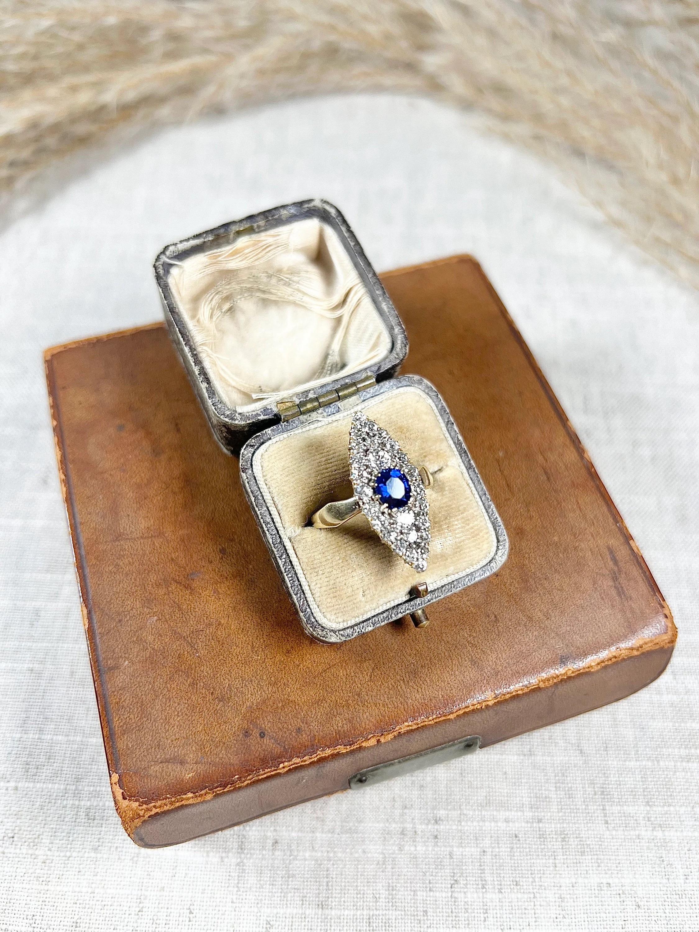 Antique Sapphire Marquise Ring 

18ct Gold Tested

Circa 1870s

This stunning Victorian ring is crafted from 18ct gold and features a marquise shape adorned with an exquisite oval, faceted natural sapphire at its centre. Surrounding the sapphire are