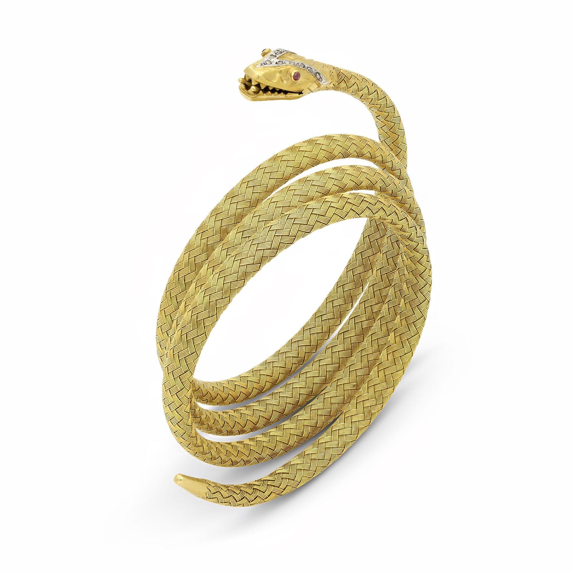An antique French yellow gold snake bracelet, circa 1870. The bracelet is designed to wrap around the wrist, the woven 18ct yellow gold braided to be highly flexible, one end featuring a snake's head with open mouth and engraved and decorated with