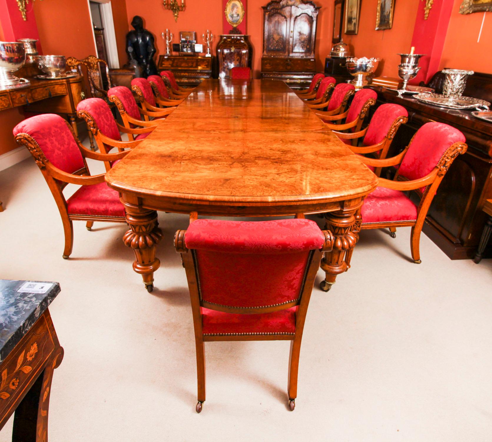 There is no mistaking the style and sophisticated design of this exquisite dining set comprising a rare English antique Victorian pollard oak  extending dining table circa 1860 in date and an antique set of fourteen Irish oak open armchairs circa