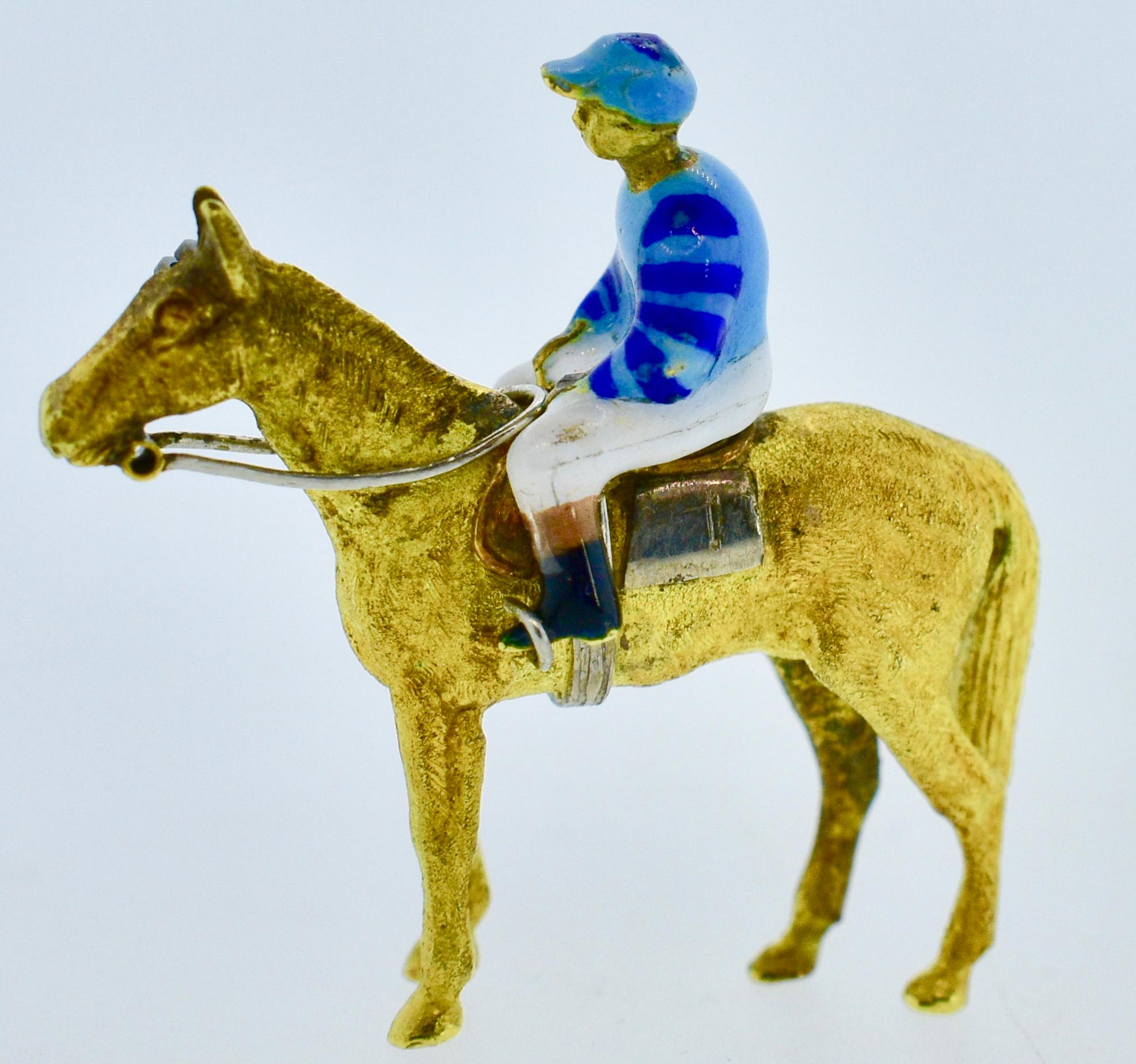 Antique horse and jockey 18K brooch.  Well made by the English firm A&W (best know for equestrian motif enamel jewelry),  this antique piece is enameled with fine detail on all sides.  This piece which is 1.25 inches in length  is in fine condition