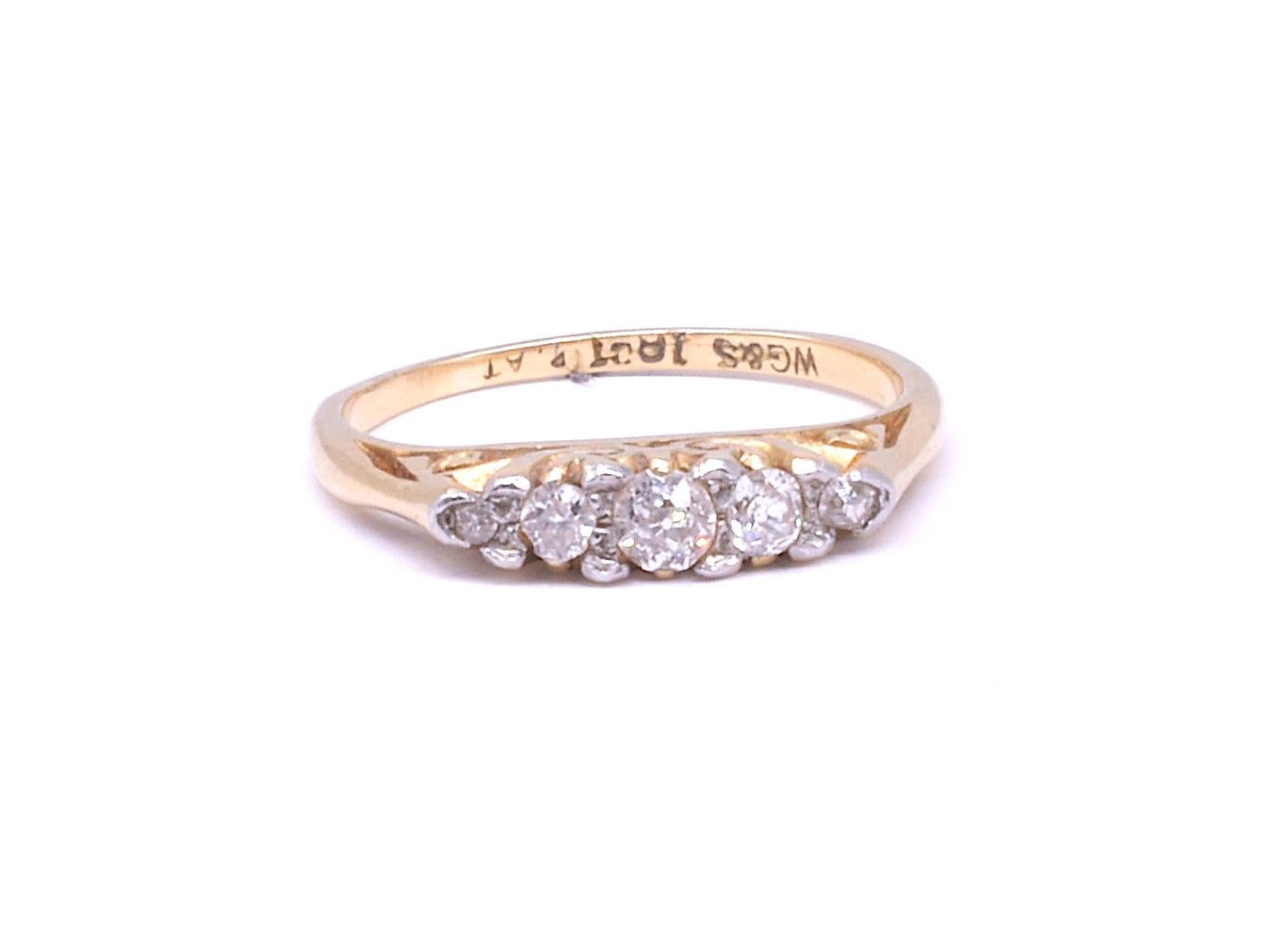 Ring of diamonds and platinum, our band has 5 cushion cut diamond atop a band incised with scrolls and 