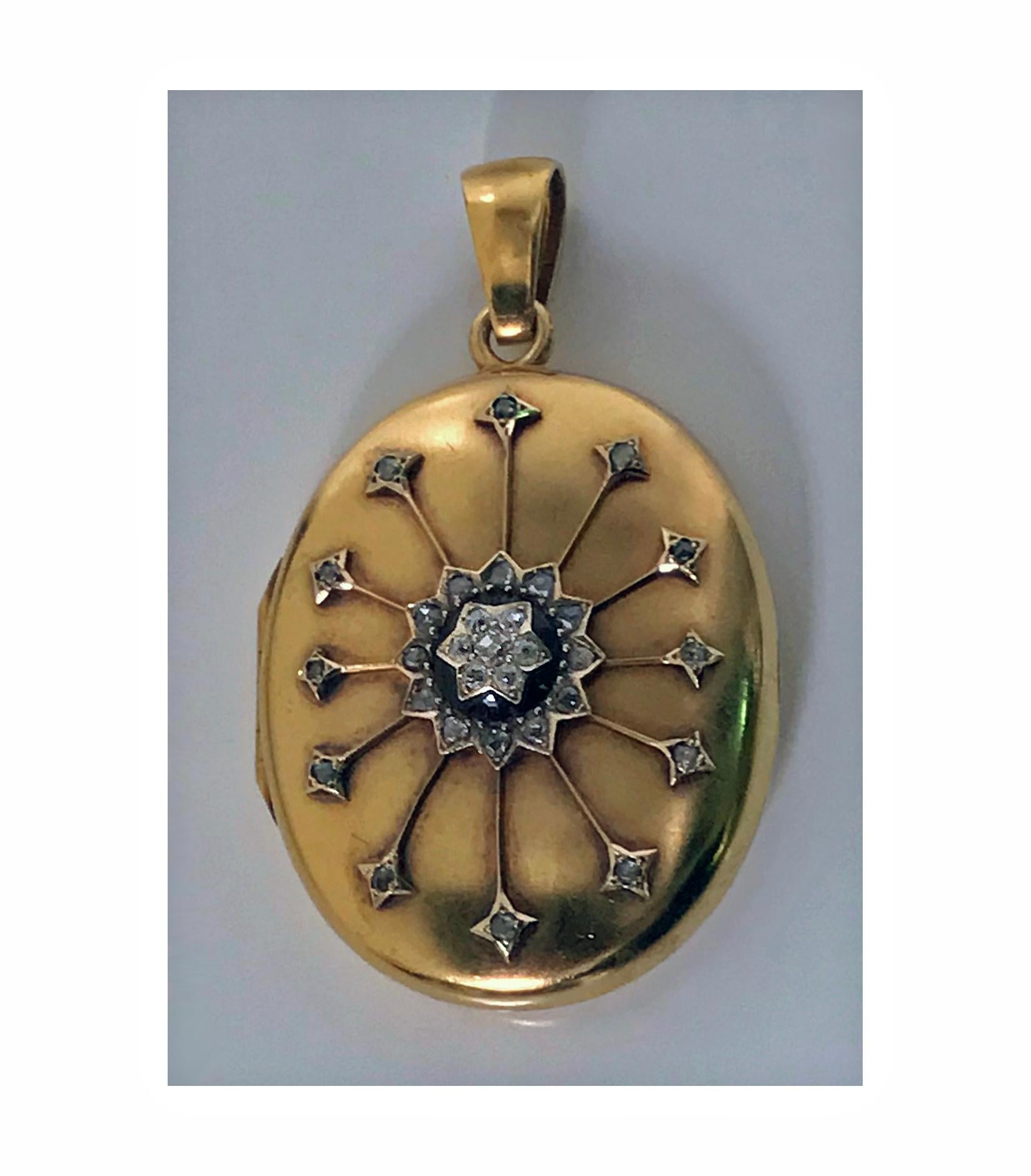 Antique 18-karat diamond large pendant locket, circa 1860. The front diamond star set centre surmounted on black onyx and diamond surround with applied gold diamond rays extending outwards, thirty one mixed old mine cut and rose cut diamonds, all on