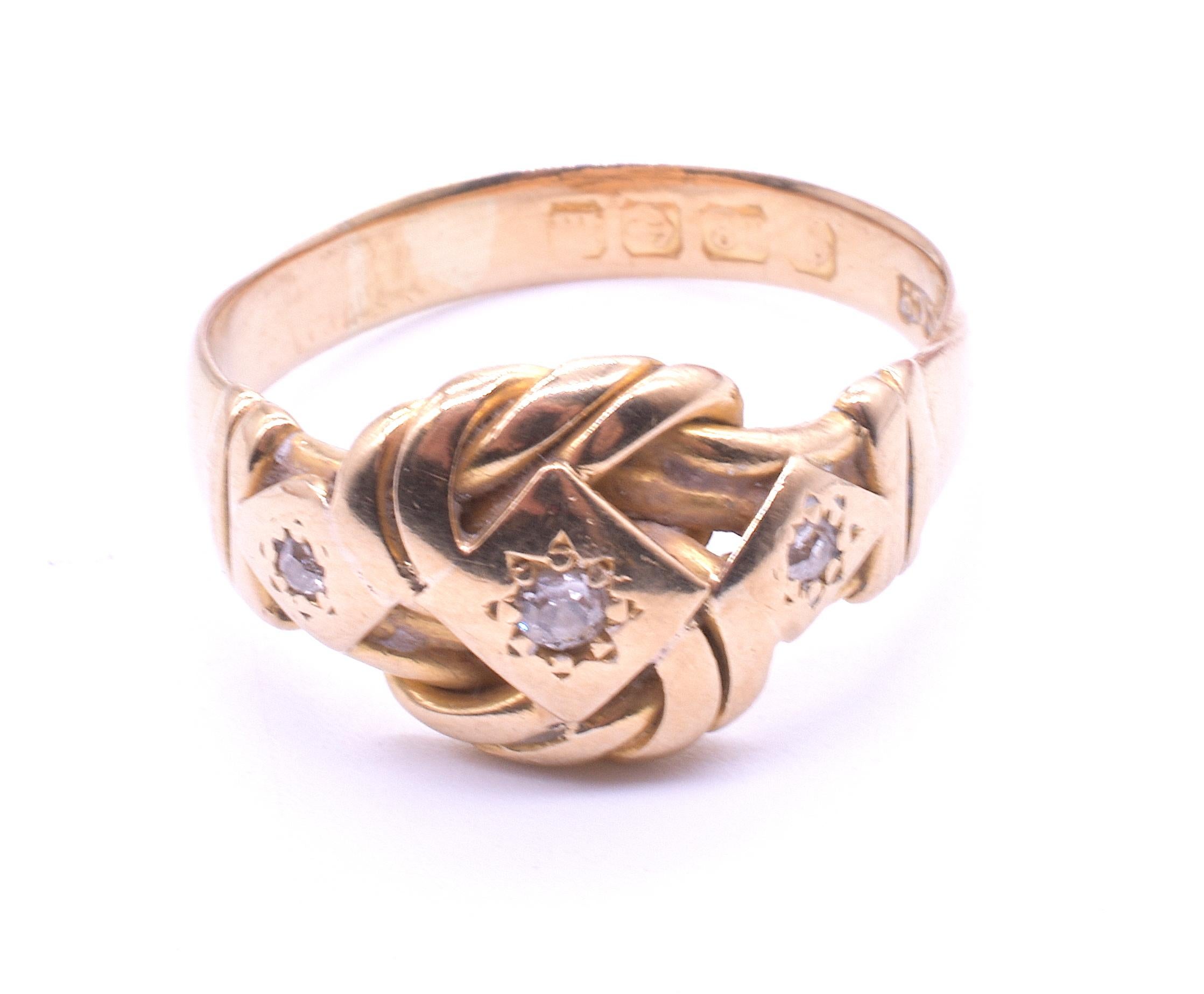 Antique 18K and diamond-studded lover's knot ring hallmarked for Birmingham, 1905. Lover's knots were a Victorian motif that continued in popularity through WWI. Our lover's knot ring has three old mine cut diamonds embedded securely within incised