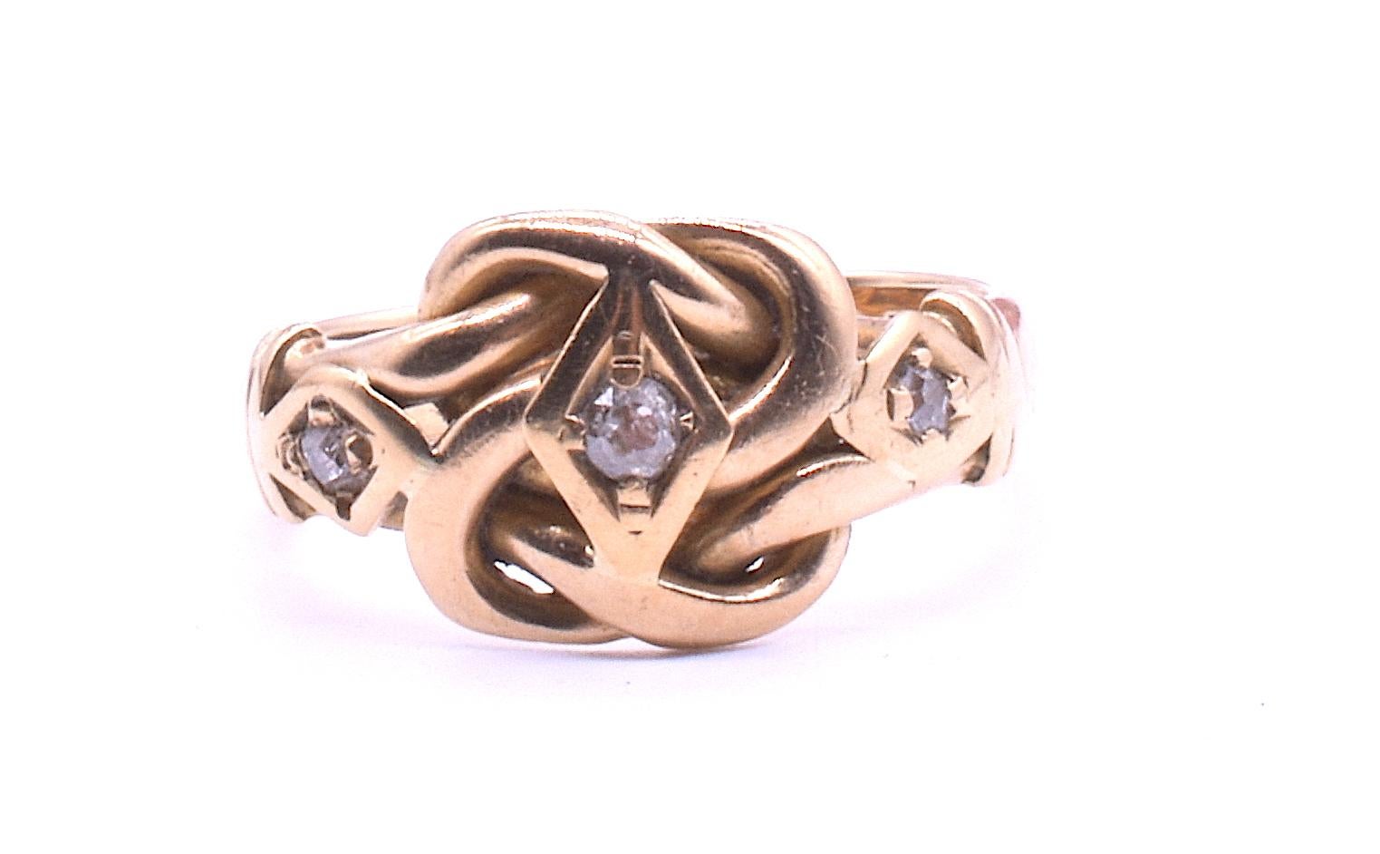Antique 18K and diamond-studded lover's knot ring with nice clear hallmarks for Chester, 1909. The knot motif is a Victorian symbol of love. It continued in popularity through WWI. Our knot ring has three old mine cut diamonds embedded securely