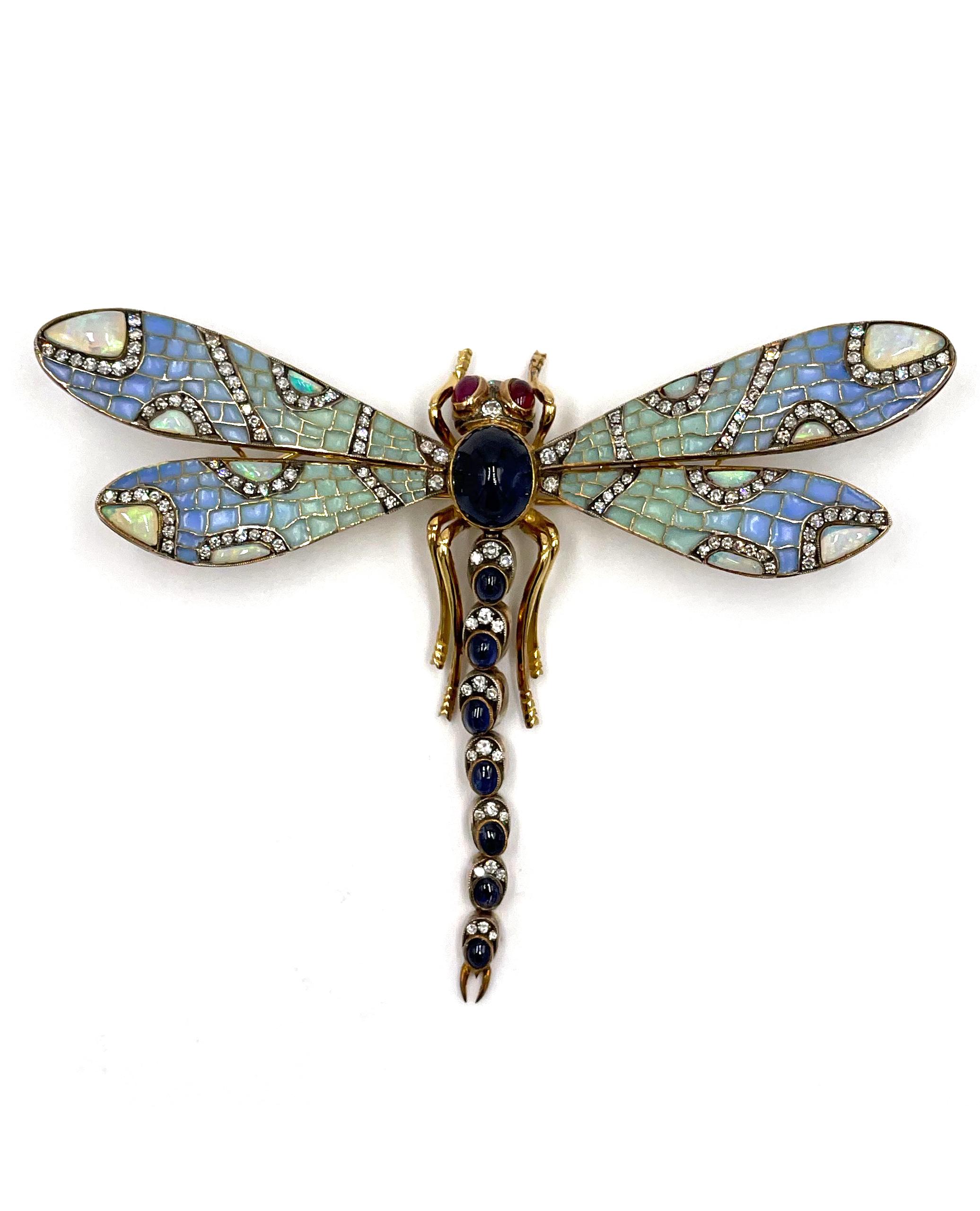 Antique, circa 1880-1910, 18K yellow gold and silver handmade dragonfly brooch/pendant slide with sapphire, opal, ruby and diamond.

The plique-a-jour wings are pale blue/green enamel and set with 12 opals.  The veins in the wings are silver, set