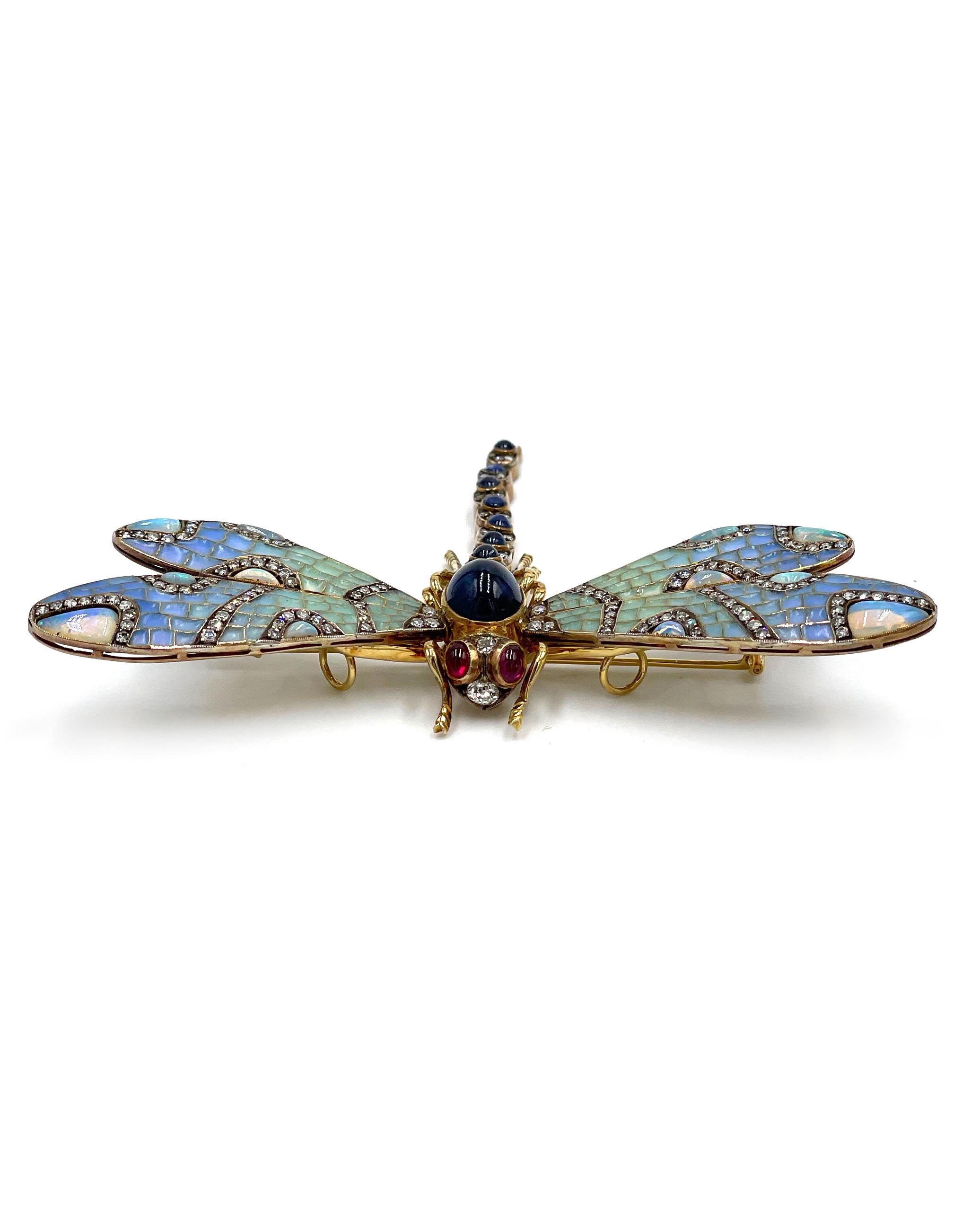 Antique, circa 1880-1910, 18K yellow gold and silver handmade dragonfly brooch/pendant slide with sapphire, opal, ruby and diamond.

The plique-a-jour wings are pale blue/green enamel and set with 12 opals.  The veins in the wings are silver, set