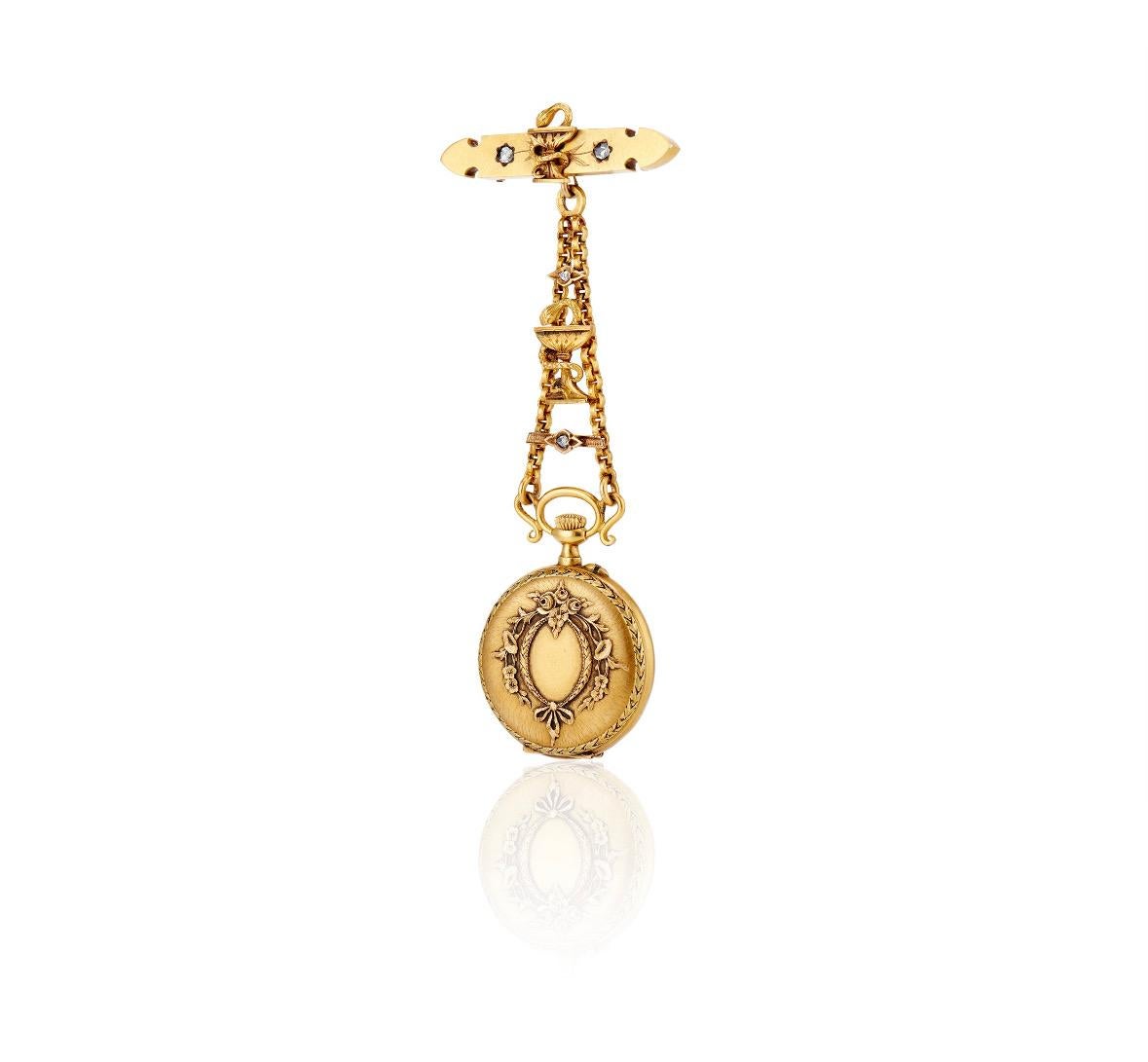 This exceptional 18k bicolor French pendant watch is suspended by a graduated banner, elaborately decorated by a Bowl of Hygieia centered between two twinkling rose-cut diamonds. This banner attaches to a small 1 9/16
