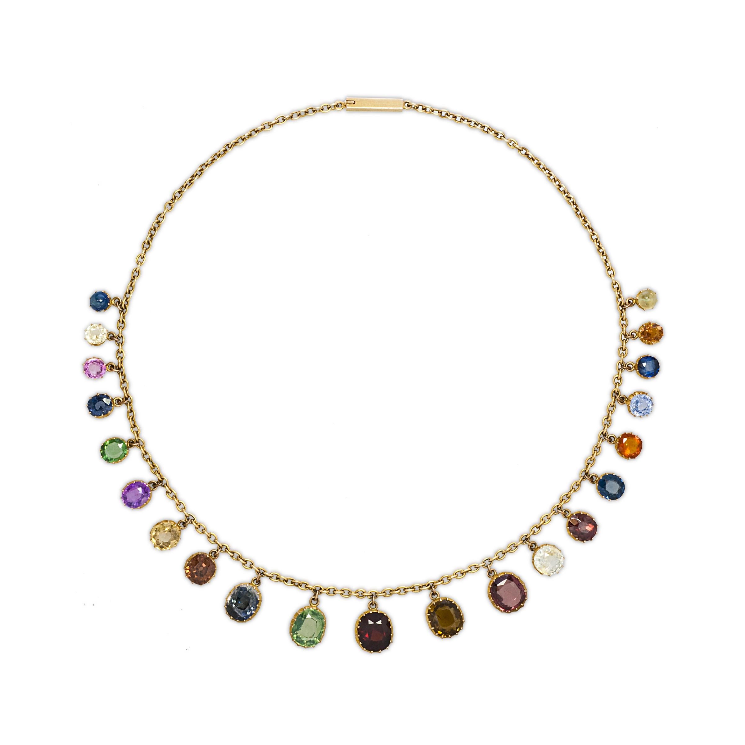 Antique 18K Gold and Multi-Colored Gemset Necklace; circa 1880
21 graduated precious and semi precious gem stones (topaz, amethyst, garnets, citrines, sapphires, tourmalines and zircon.)

