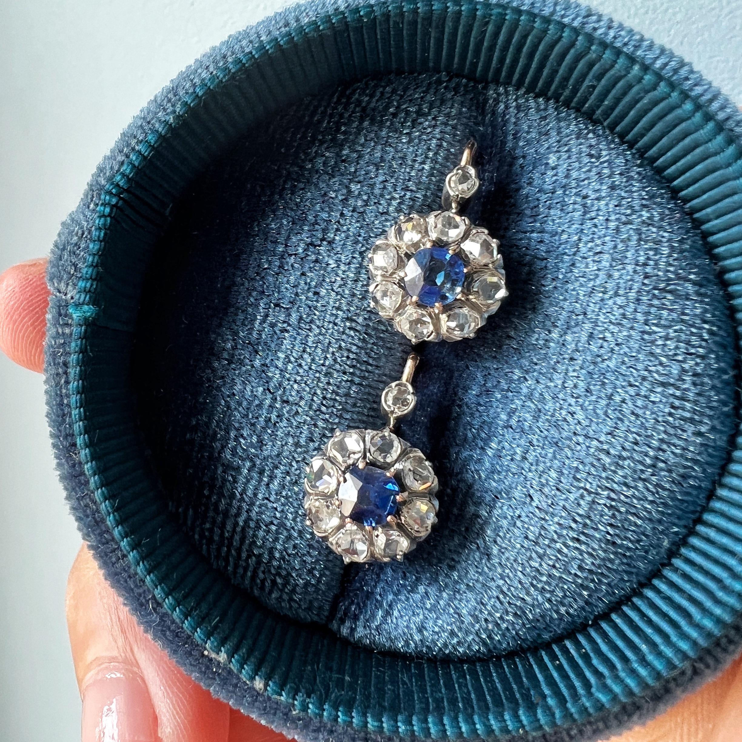 For sale a beautiful pair of French antique diamond blue sapphire earrings in 18K gold, dated back to the late 19th century, the Victorian era.

Each side of the earrings features a cluster design of a flower made of a halo-styled rose cut diamonds