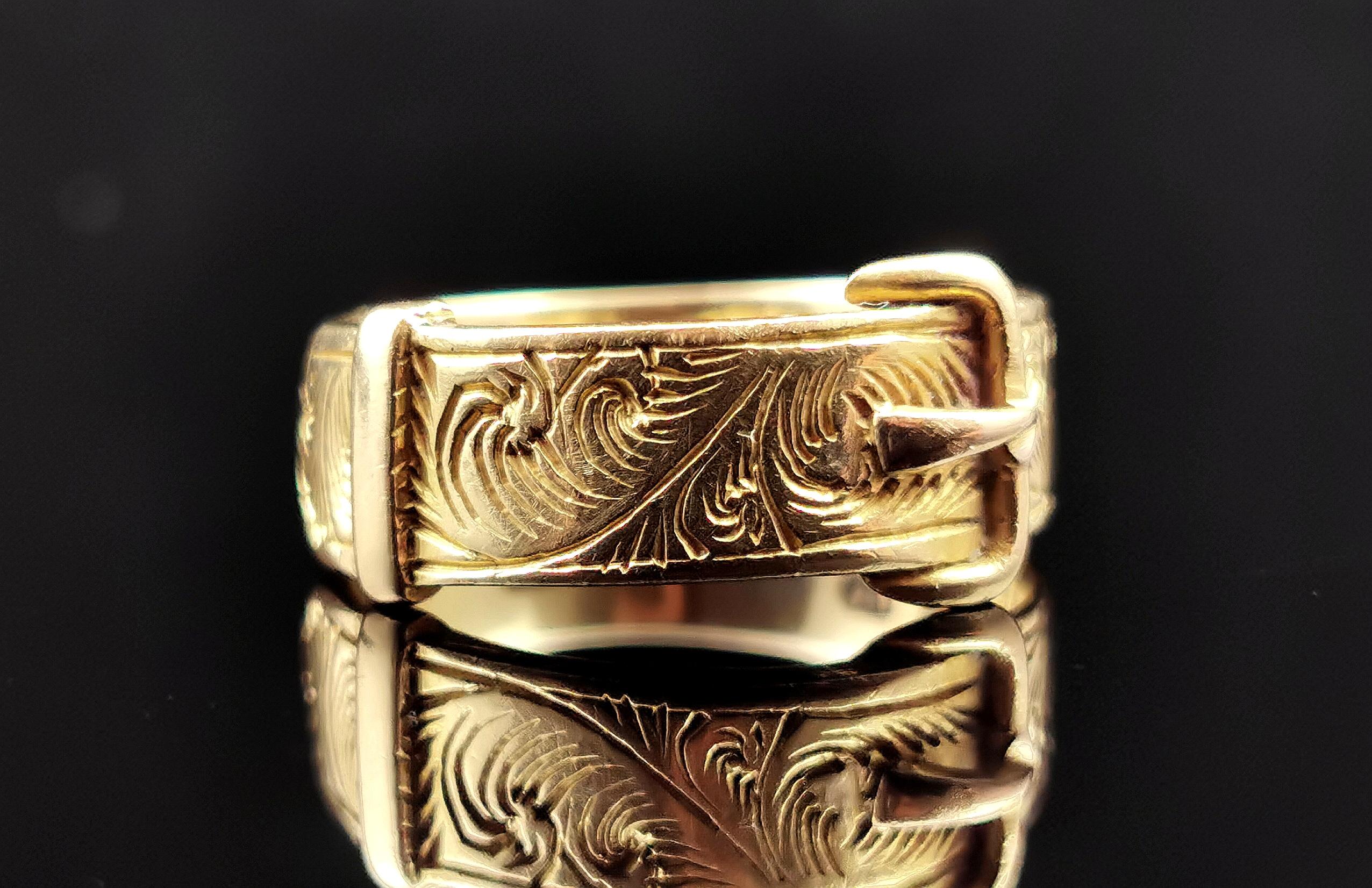 A stunning antique 18ct gold Buckle ring.

The rich gold band is engraved with flora and foliate and it has a buckle front design, the buckle traditionally symbolises holding someone close or near and this really shows the sentiment in this