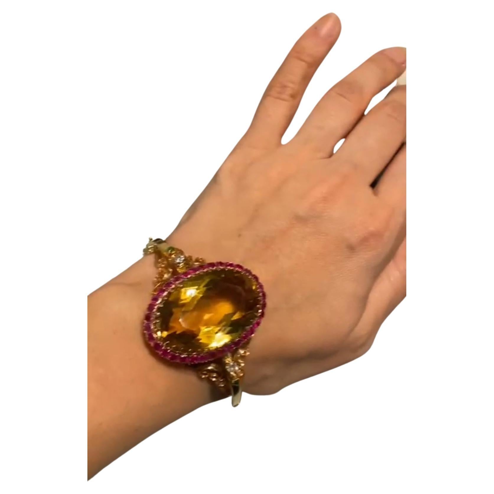 Antique 18k gold bracelet centered with large citrine stone with a diameter of 37mm×27mm estimate weight 70 carats flawless in excellent facets and spark flanked with natural red rubies and 2 old diamonds and green emeralds made in europe
