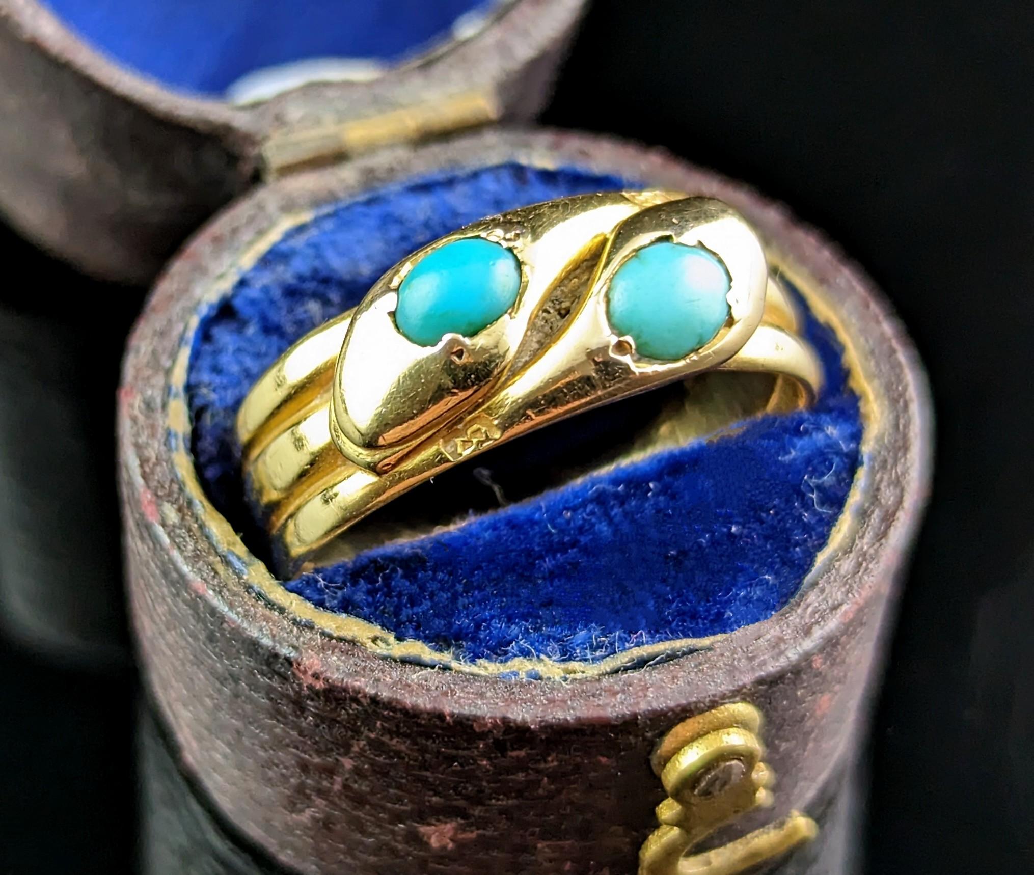 This charming antique, Victorian turquoise double snake ring in 18kt yellow gold is both unusual and alluring.

Coils of rich, buttery yellow gold form the body of these handsome intertwined snake pals, the heads are modelled at the face of the ring